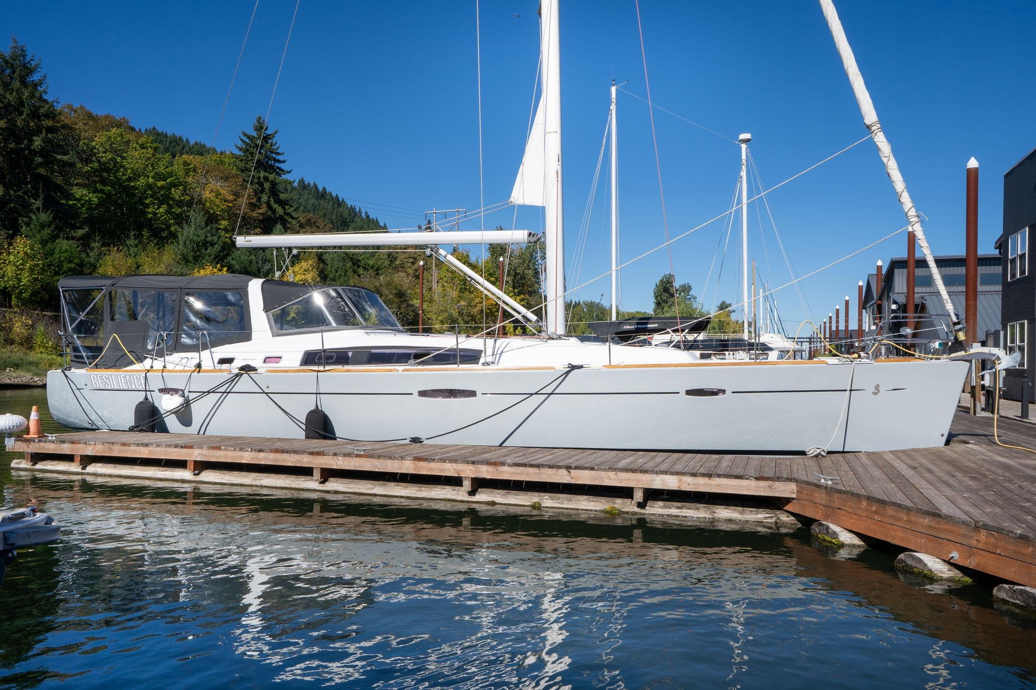 2013 Beneteau Oceanis 50 sailboat docked at marina, clear blue sky background.