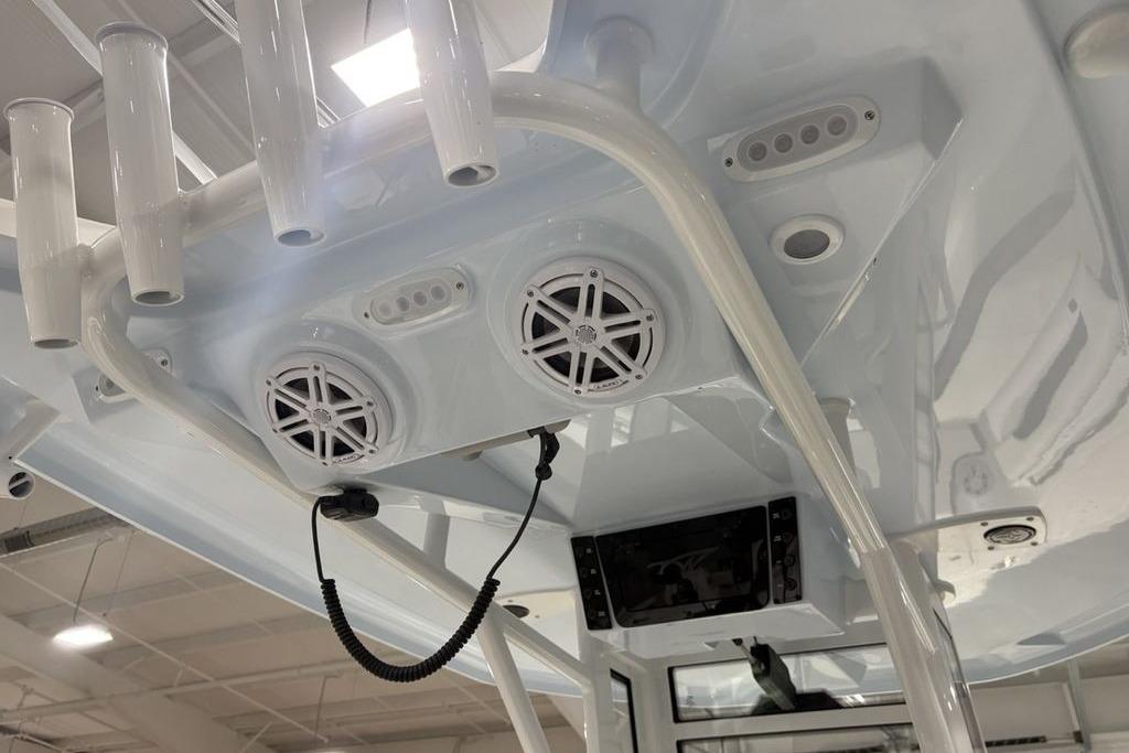 2026 Tidewater 232 CC Adventure boat interior with speakers and rod holders.