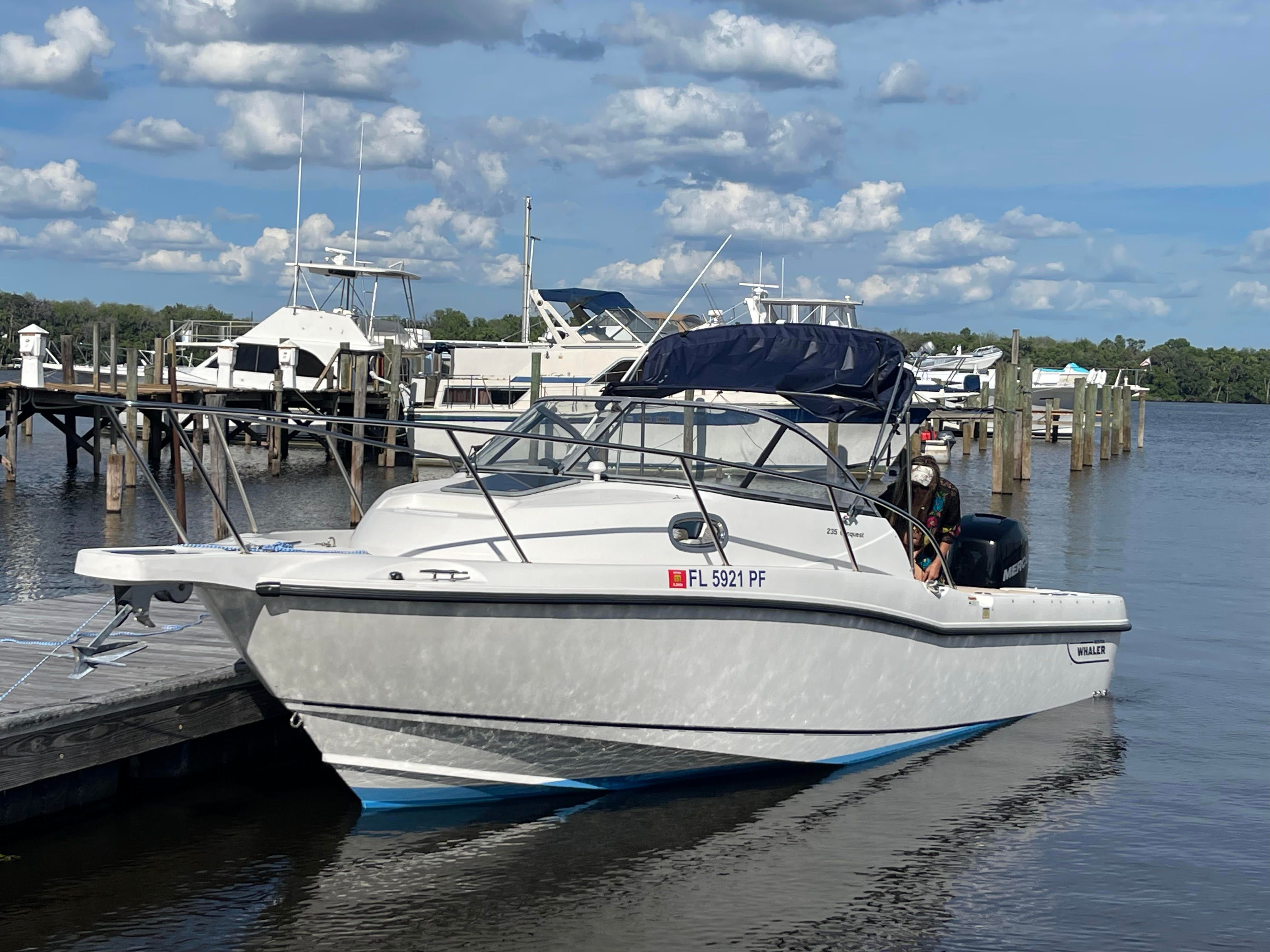 2010 Boston Whaler 235 Conquest docked on a sunny day.