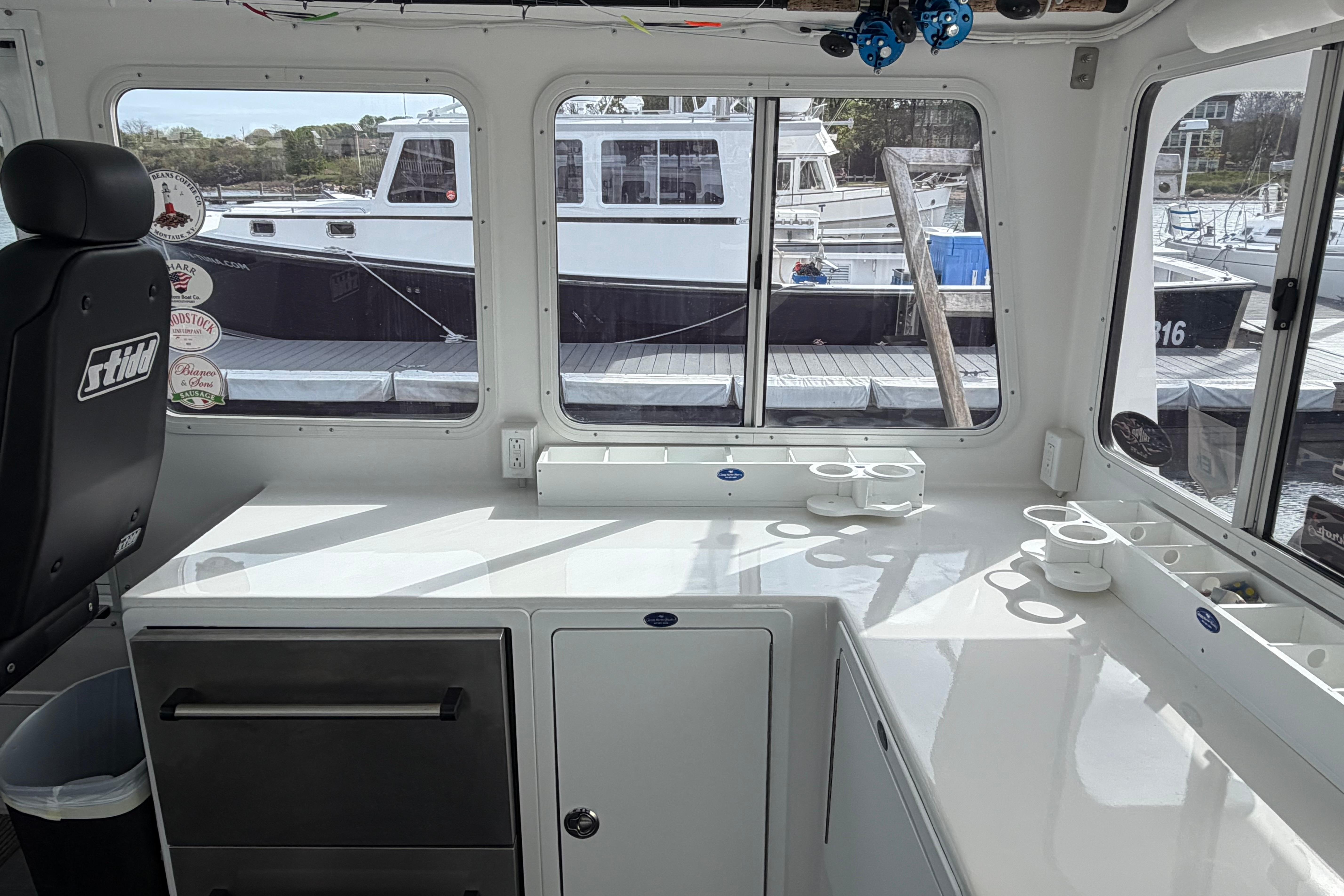 Interior of a 2018 H&H Marine Osmond Beal boat with dock view.