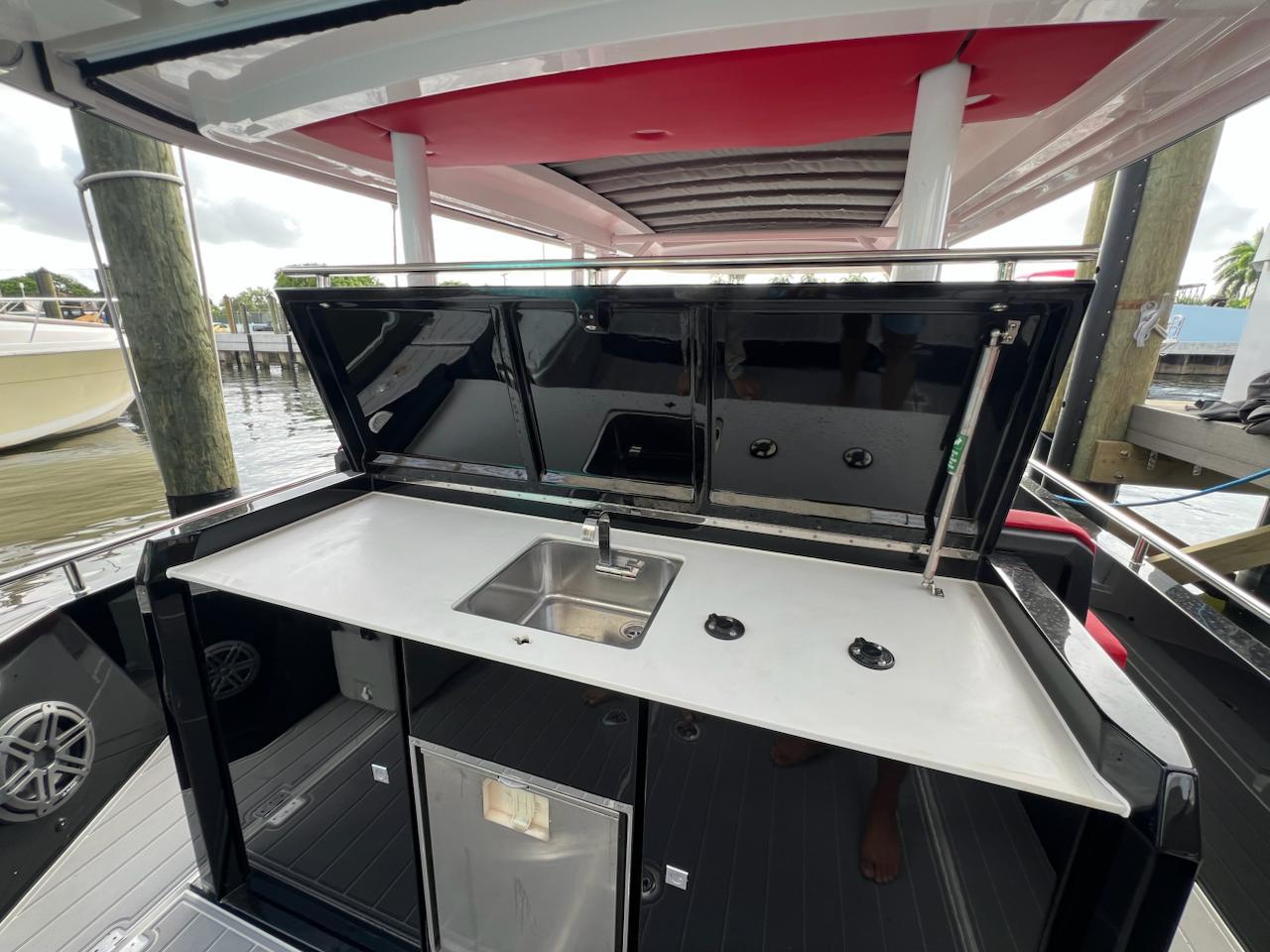 2018 Axopar 37 Sun Top boat with outdoor kitchenette and sink.