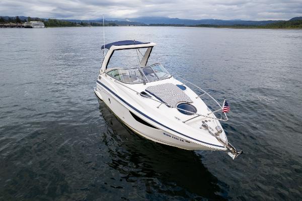 2016 Regal 28 Express boat on calm water with American flag.