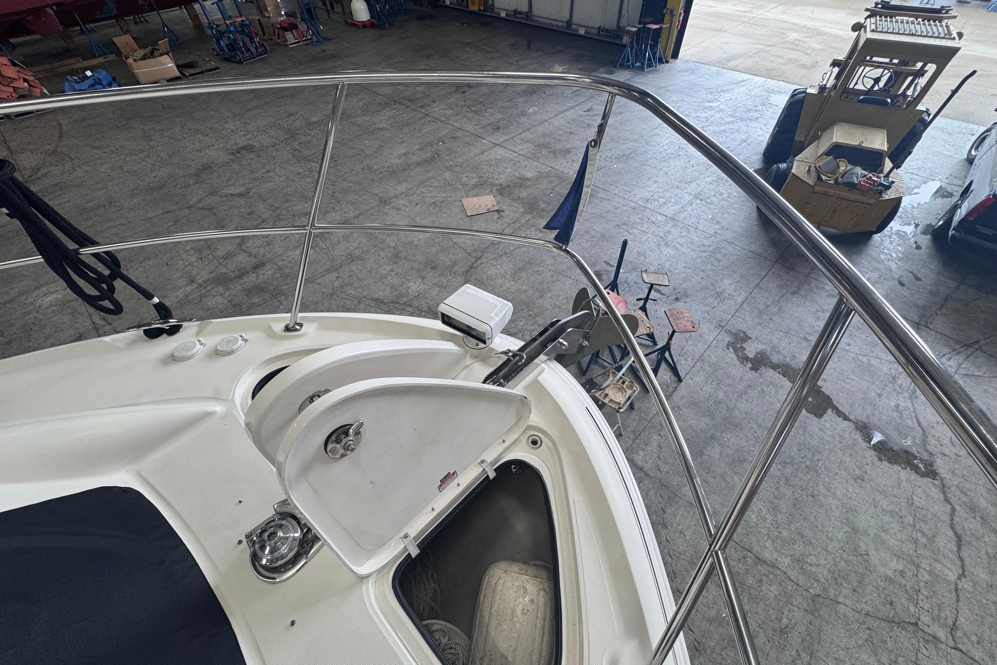 2004 Sea Ray 390 Motor Yacht bow with open storage compartment in a workshop.