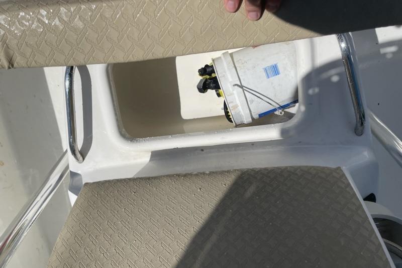 Century 1901 Bay Boat 2004 interior with storage compartment and bucket.