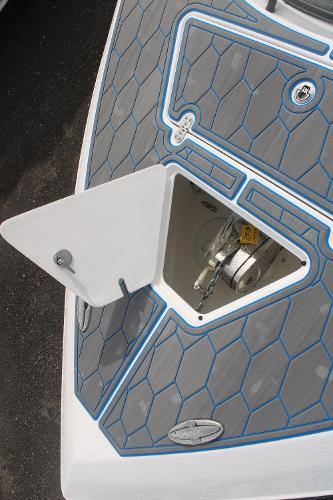 2024 Fountain 34 SC boat deck with anchor compartment, featuring hexagonal pattern design.
