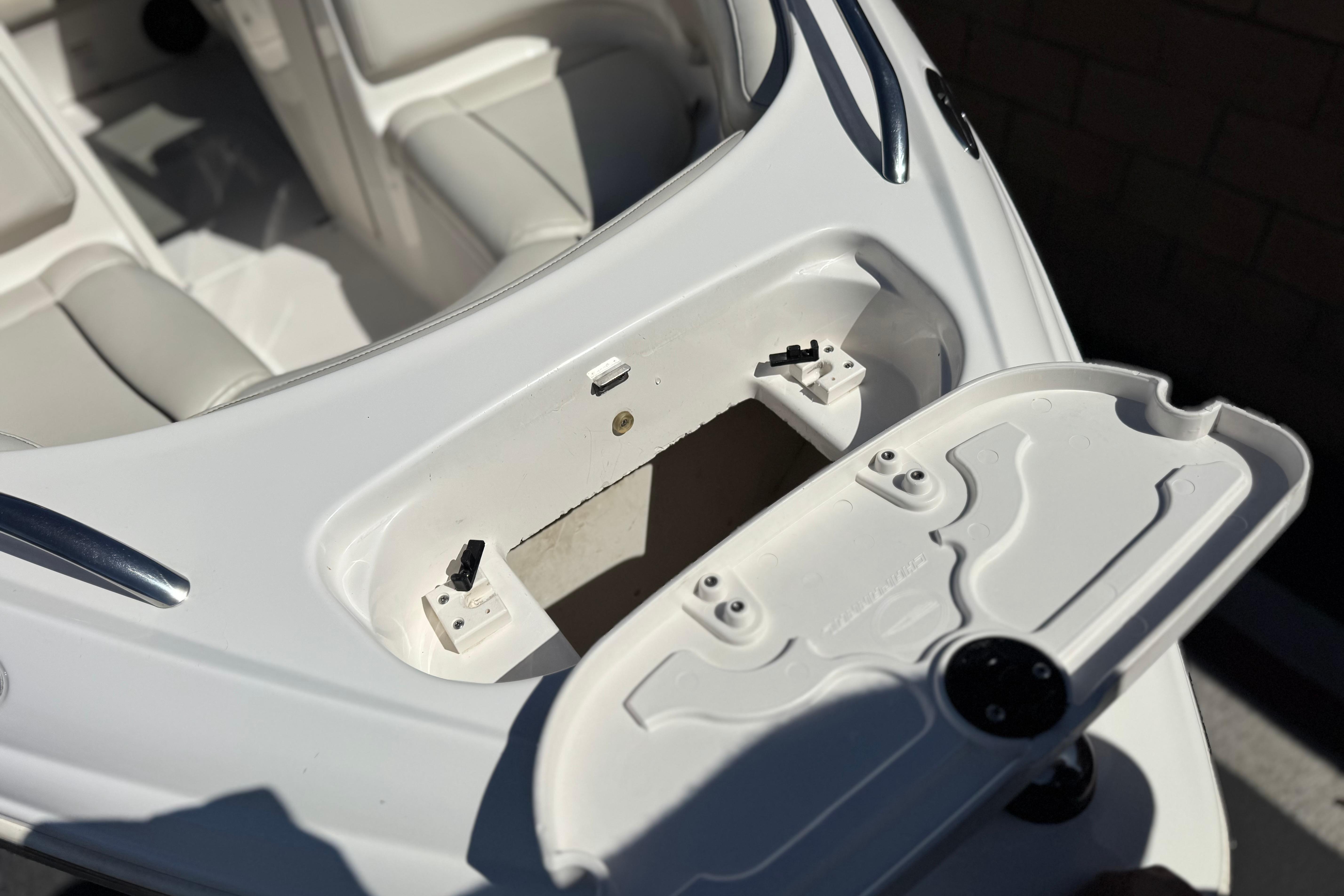 Open storage compartment on a 2002 Chaparral 186 SSi boat, showcasing interior seating.