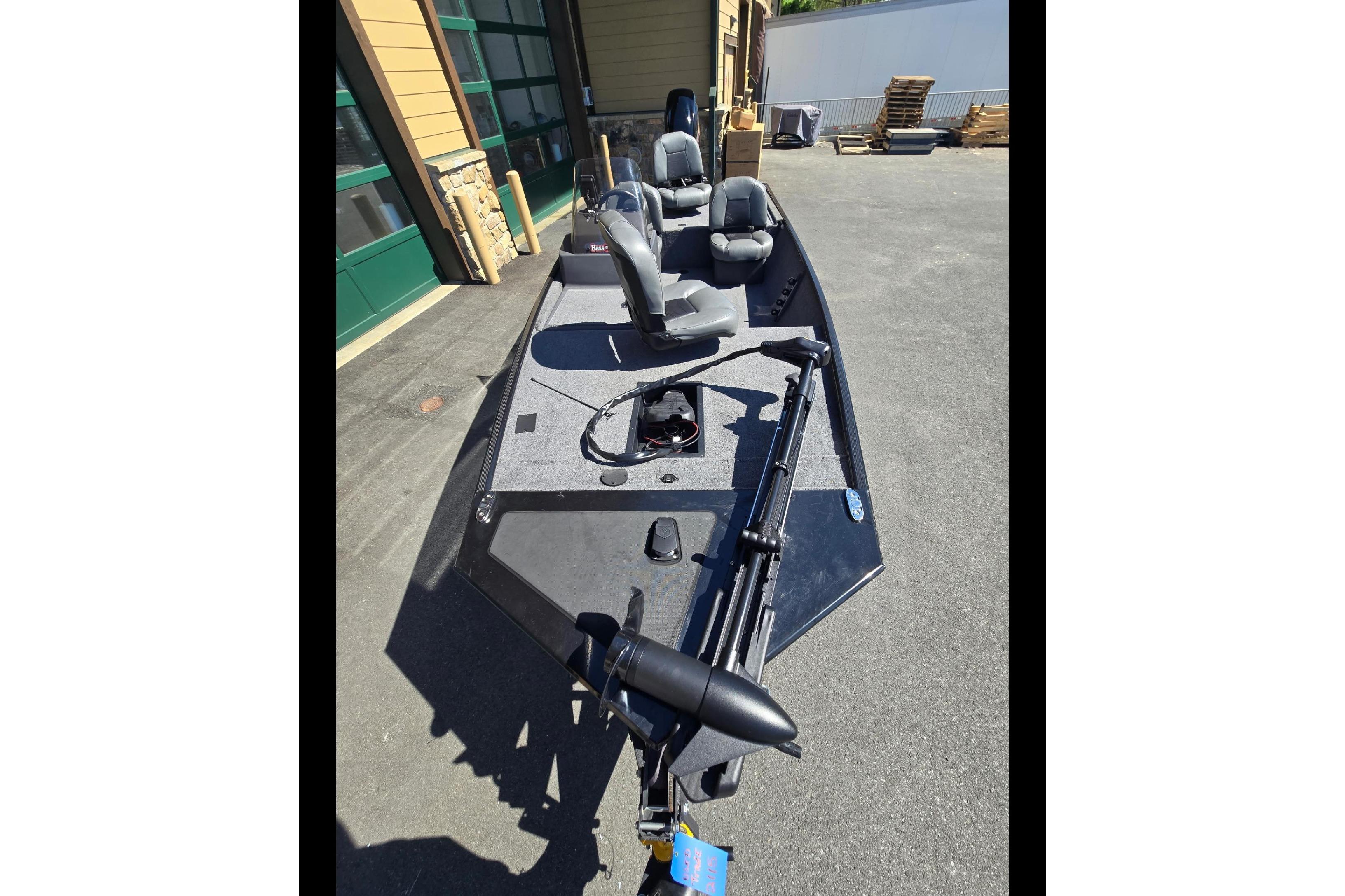 2024 Tracker Bass Tracker Classic XL boat with seating and trolling motor, parked outdoors.