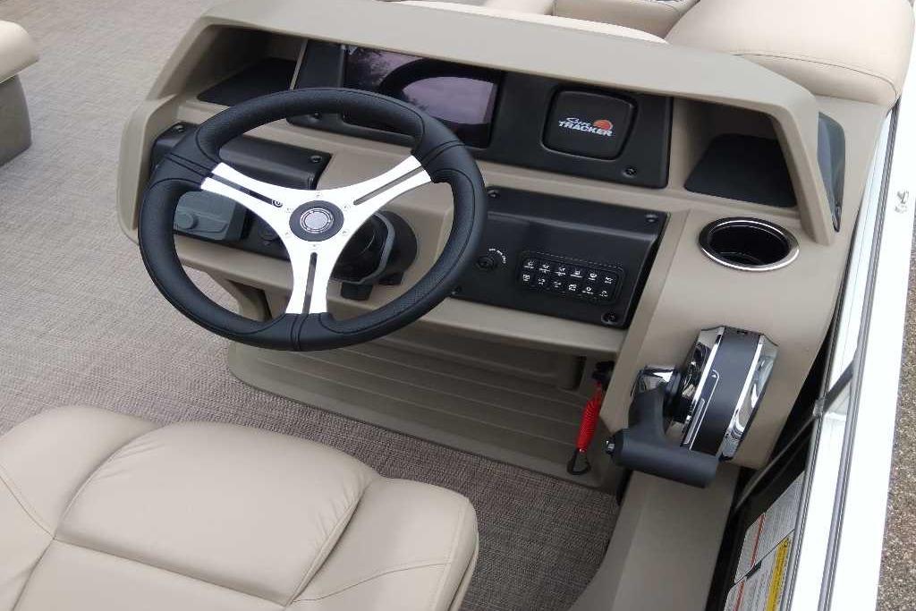 2025 Sun Tracker Sportfish 24 XP3 boat dashboard with steering wheel and controls.