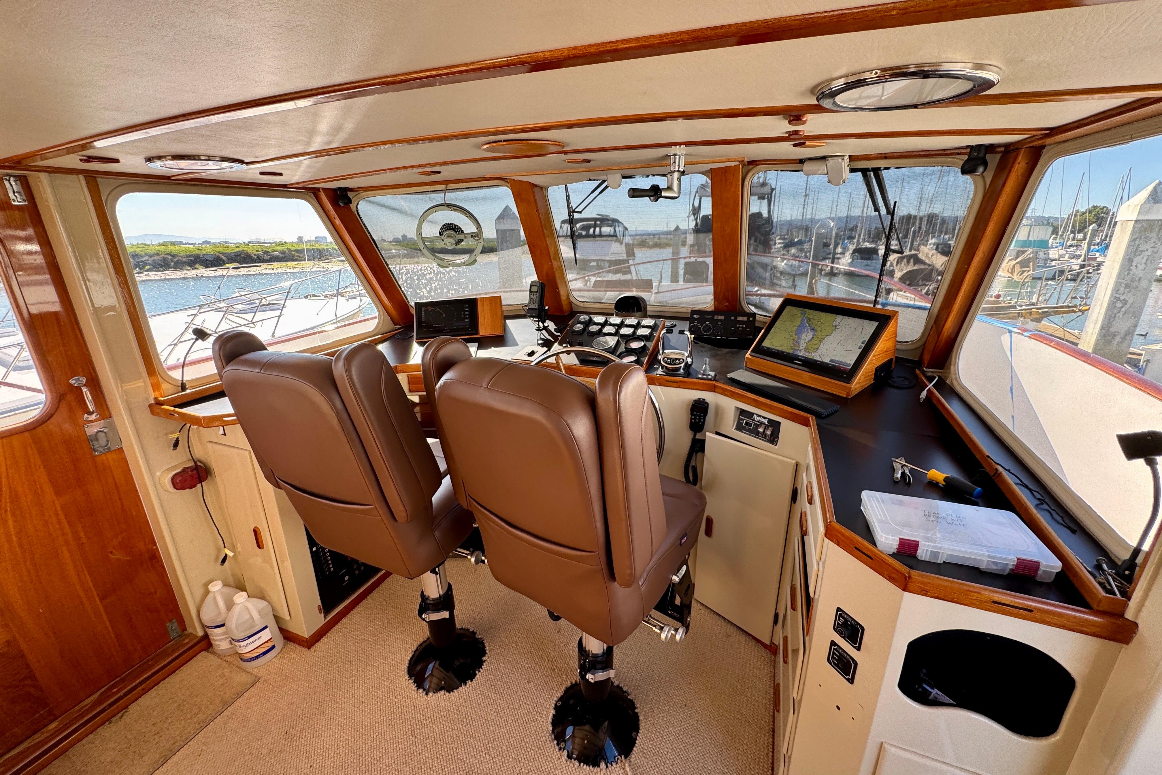 1958 Blanchard Pilothouse interior with navigation equipment and brown leather seats.