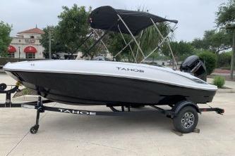 2026 Tahoe T16 boat on trailer with canopy, parked outdoors.