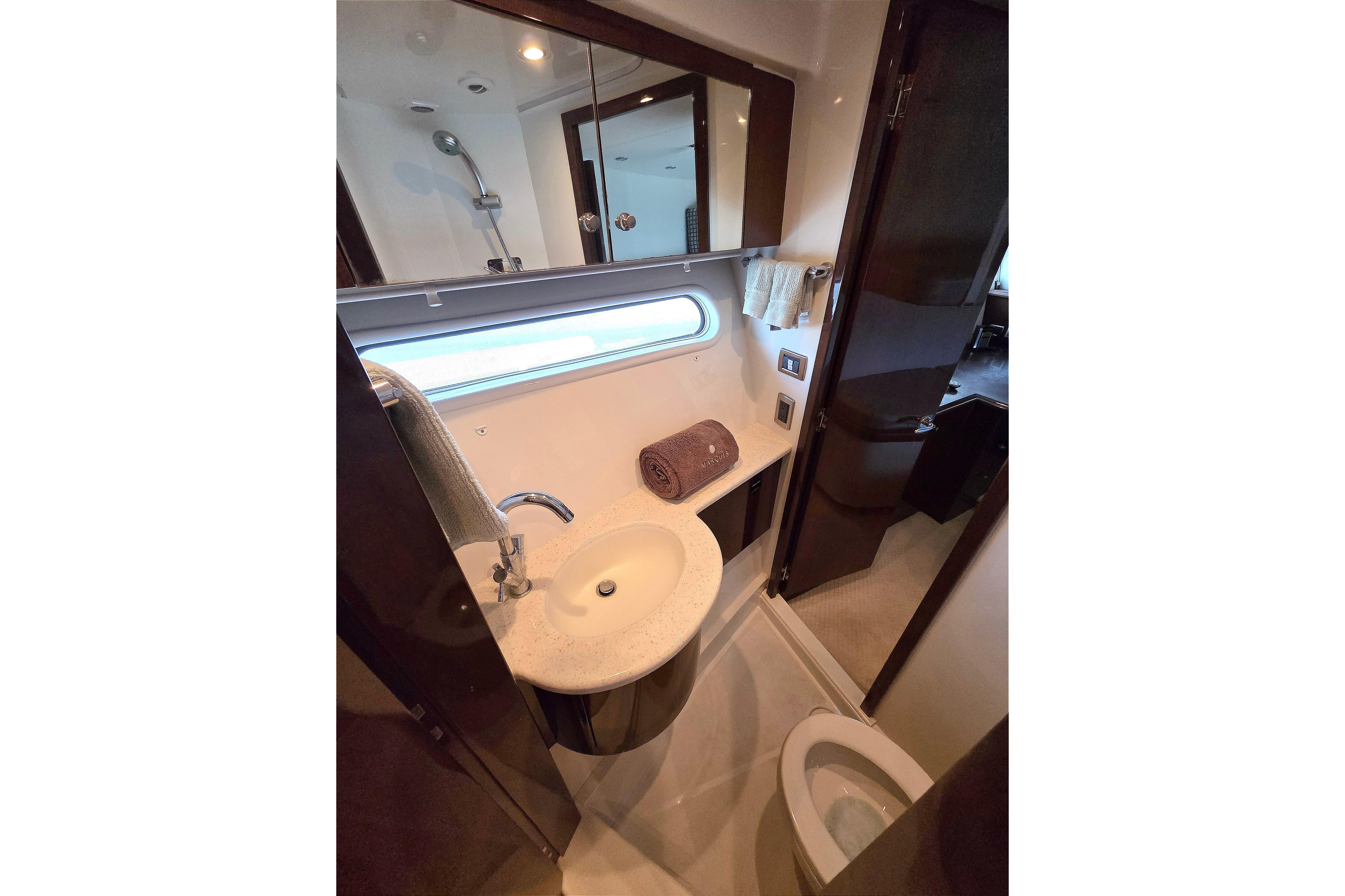 Luxurious bathroom in 2007 Marquis 55 LS yacht with modern fixtures and elegant design.