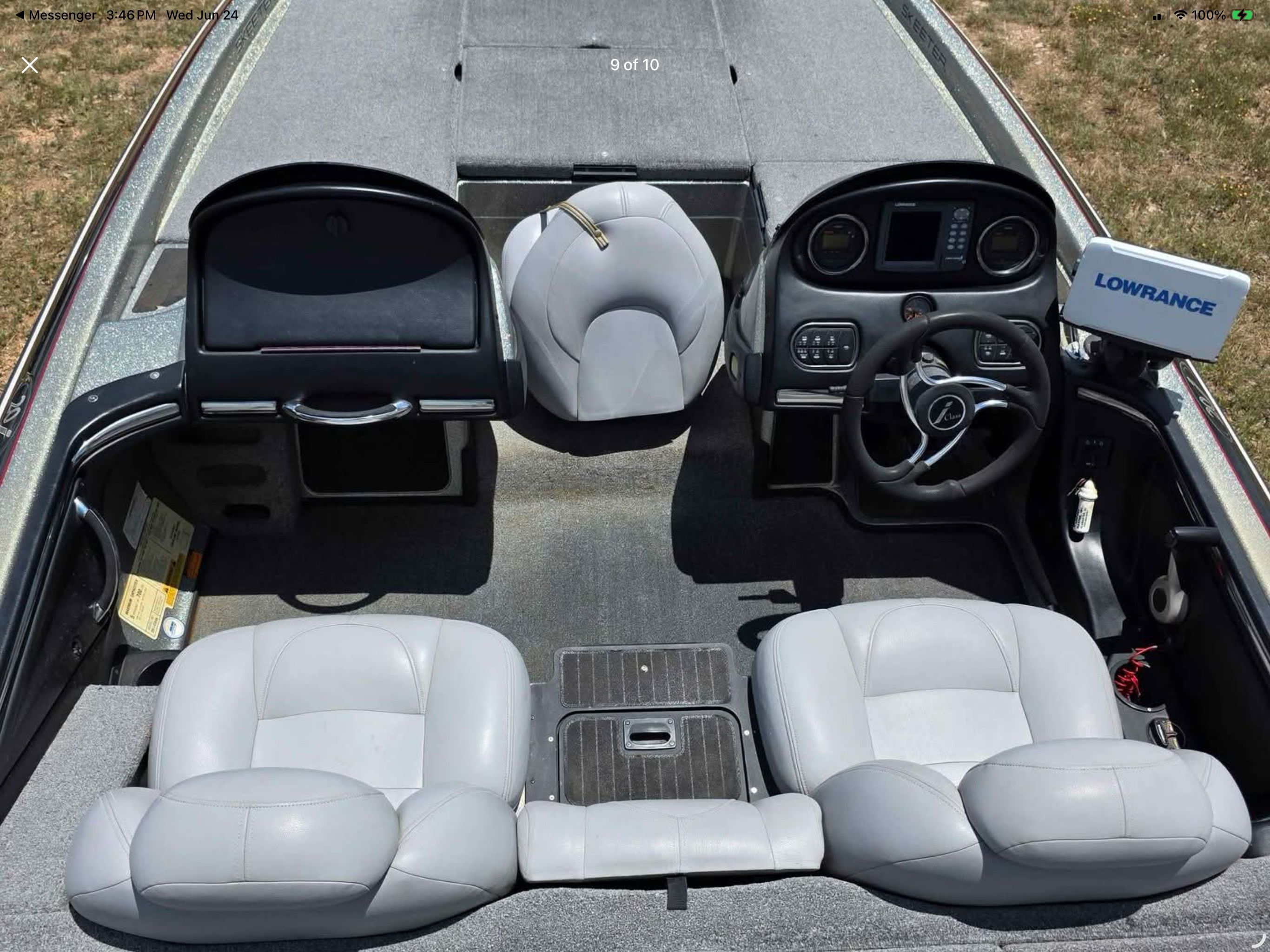 Interior view of a 2006 Skeeter 20i with gray seats and a Lowrance screen.