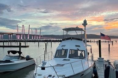 2007 Island Pilot 395 yacht docked at sunset near a bridge, with an American flag.