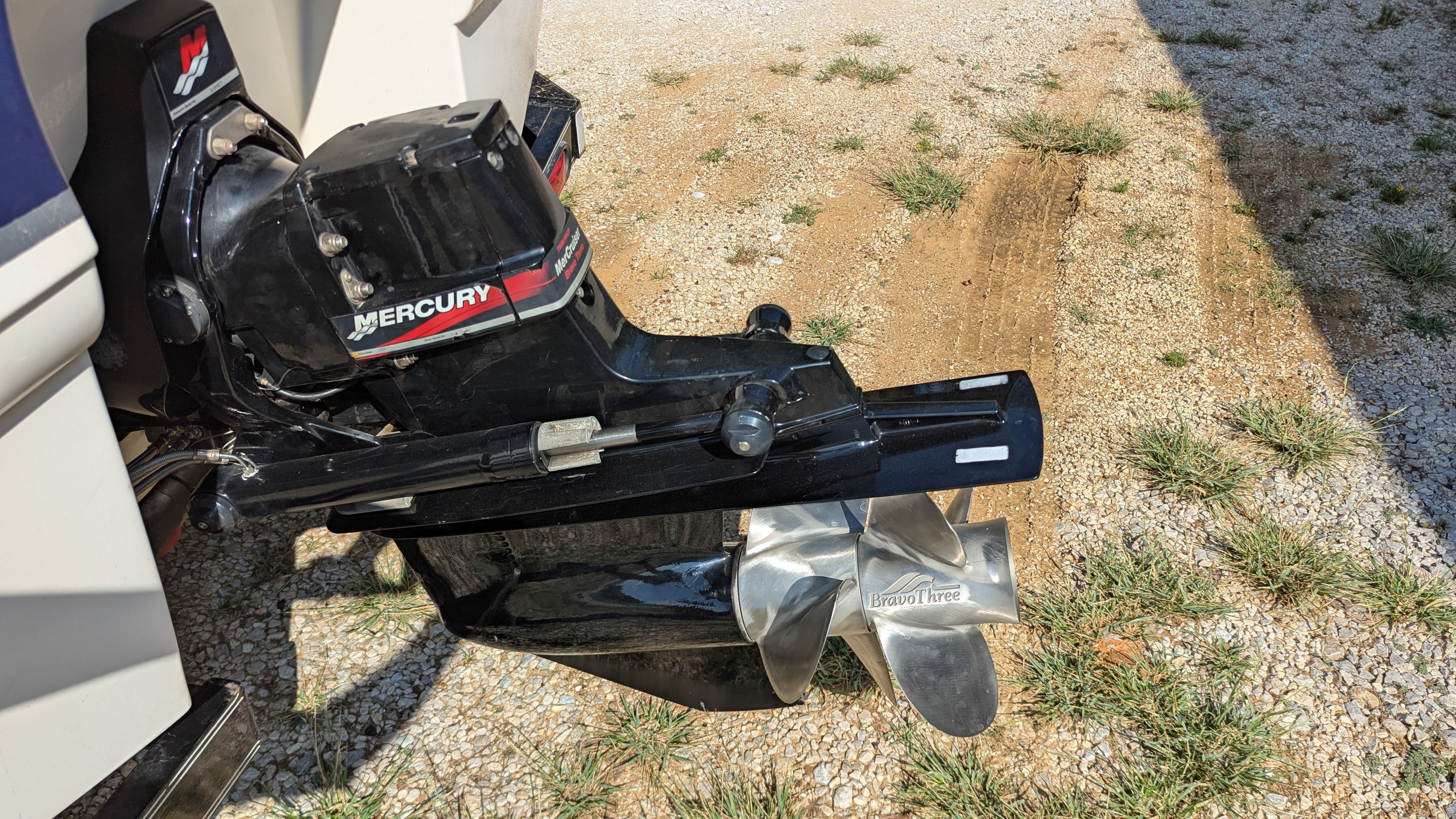 A Mercury outboard motor with a shiny propeller on a Chaparral 240 SSi boat.