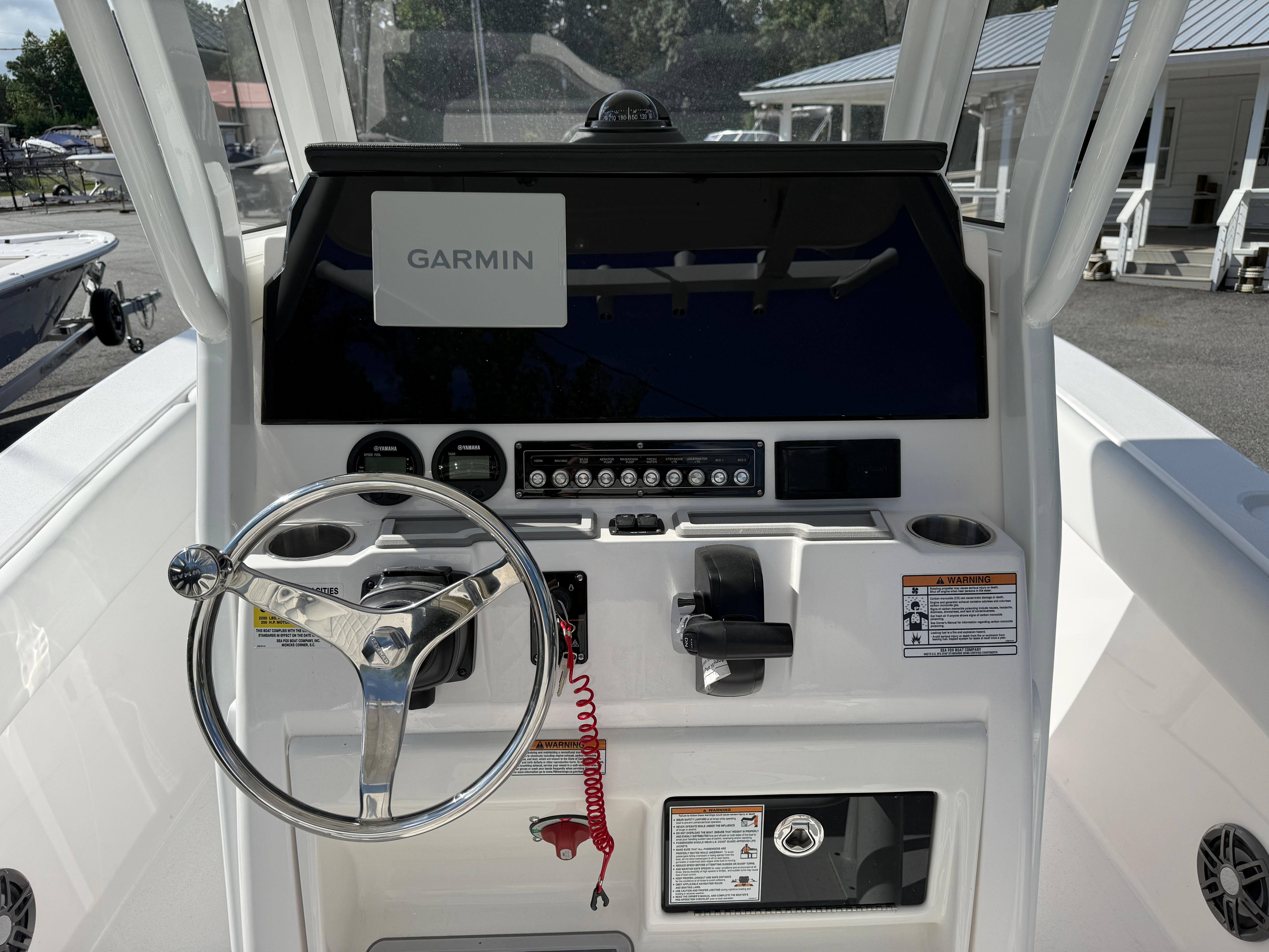 2026 Sea Fox 228 Commander boat dashboard with Garmin navigation system and steering wheel.