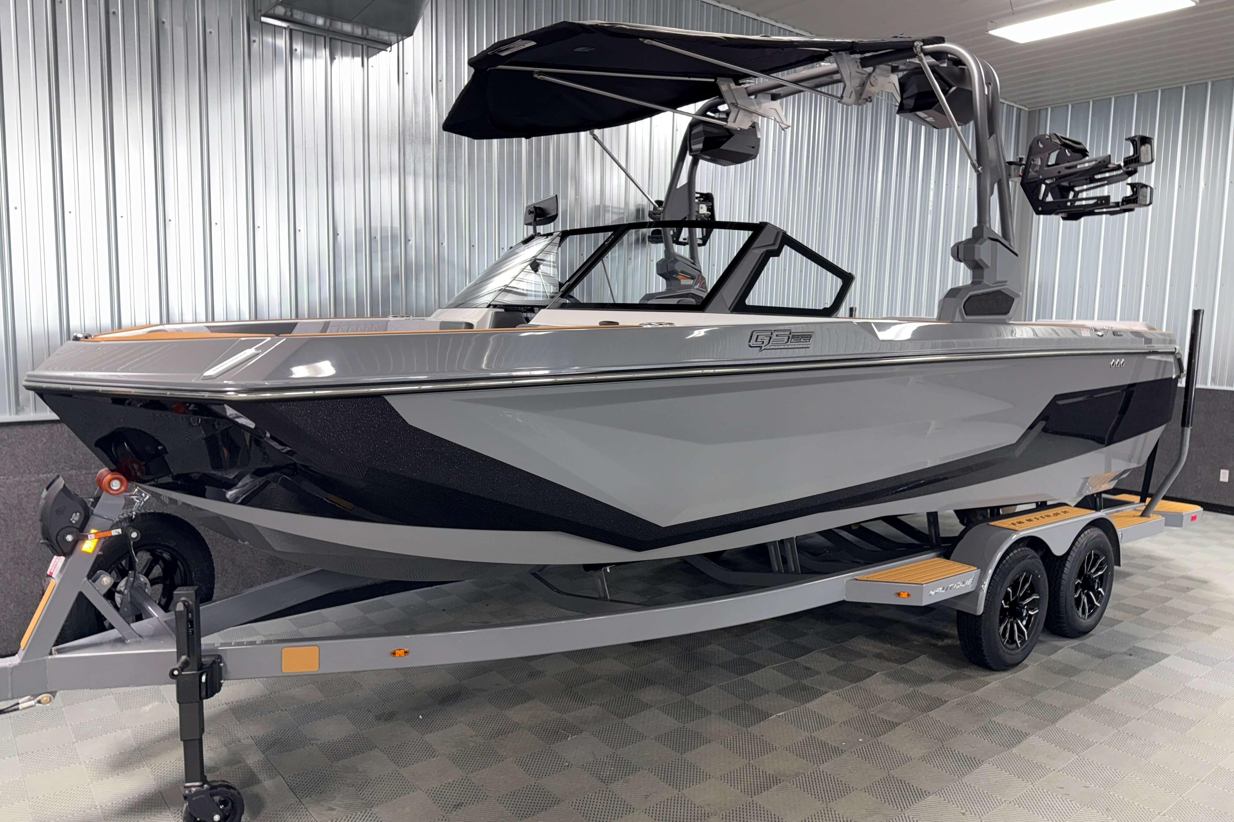 2026 Nautique Super Air Nautique GS22 boat on trailer in showroom.