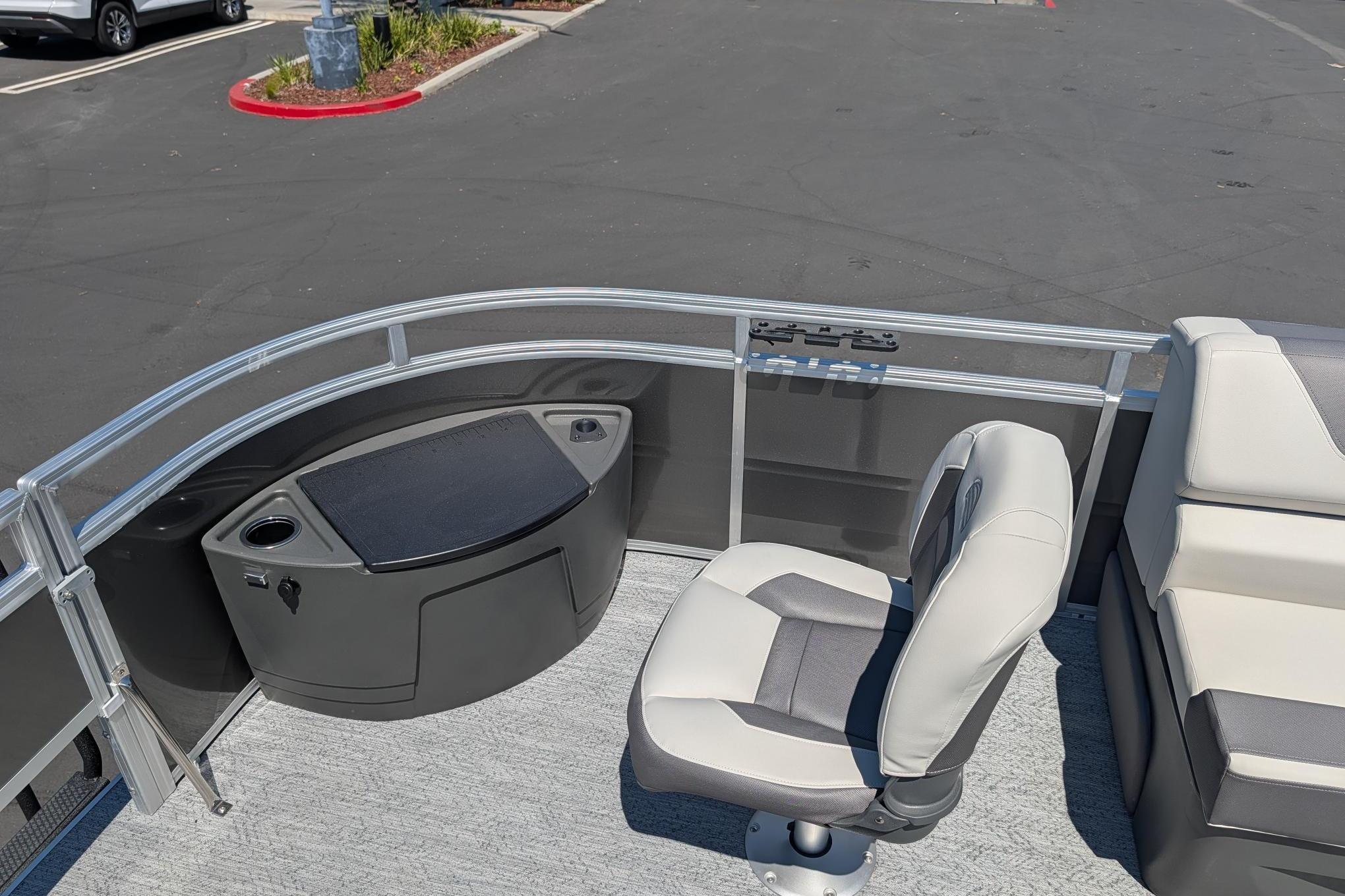 2026 Sun Tracker Fishin' Barge 22 DLX interior with seating and storage features.