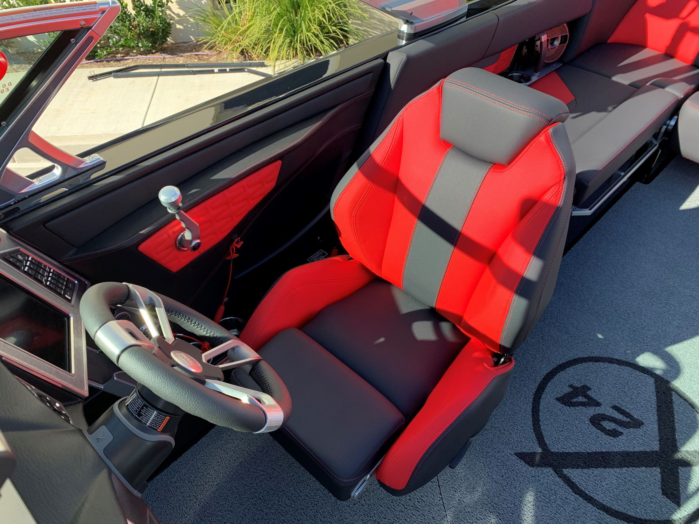 Interior of a 2020 MasterCraft X24 with red and black seating.