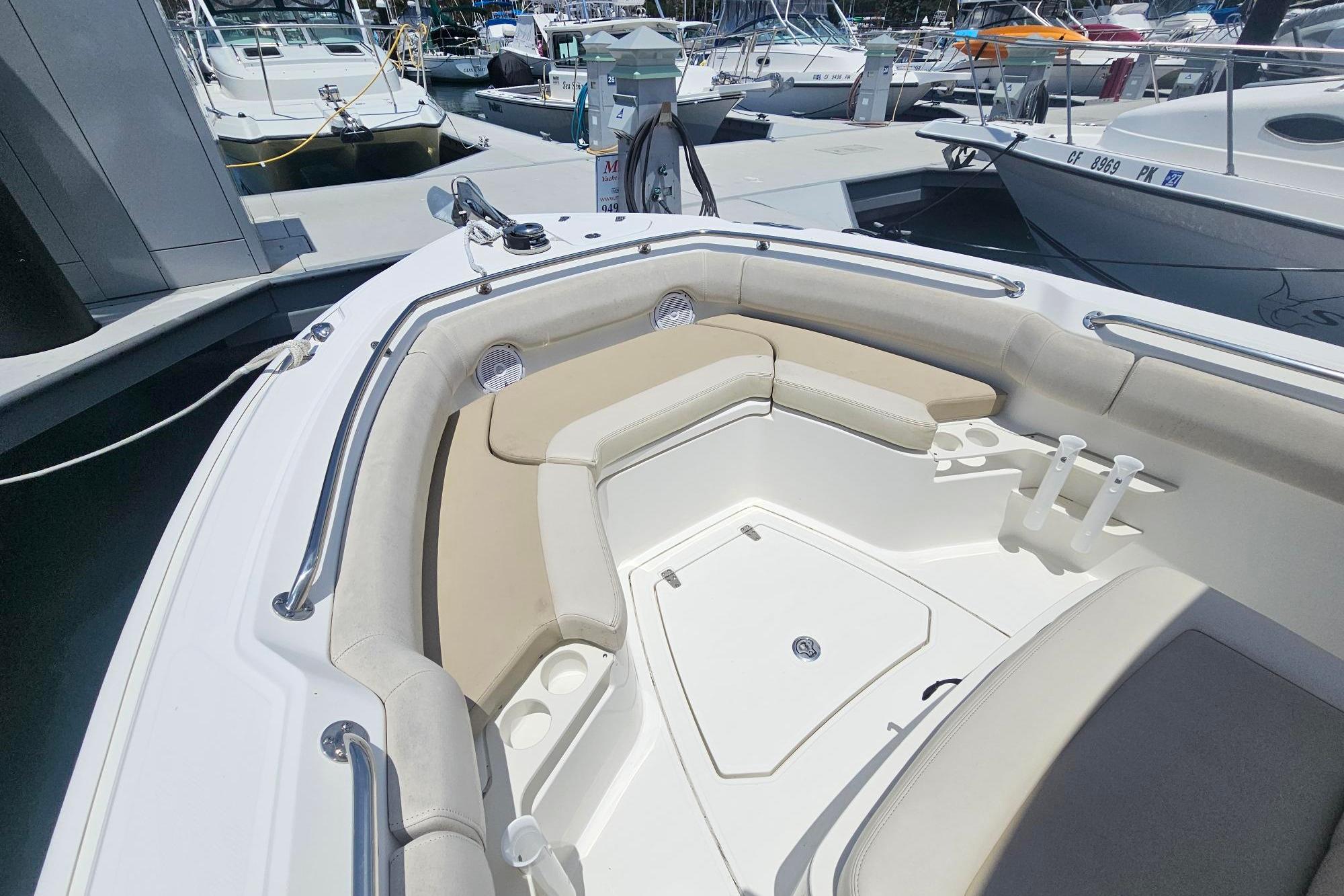 2017 Boston Whaler 230 Outrage boat interior with cushioned seating at marina.