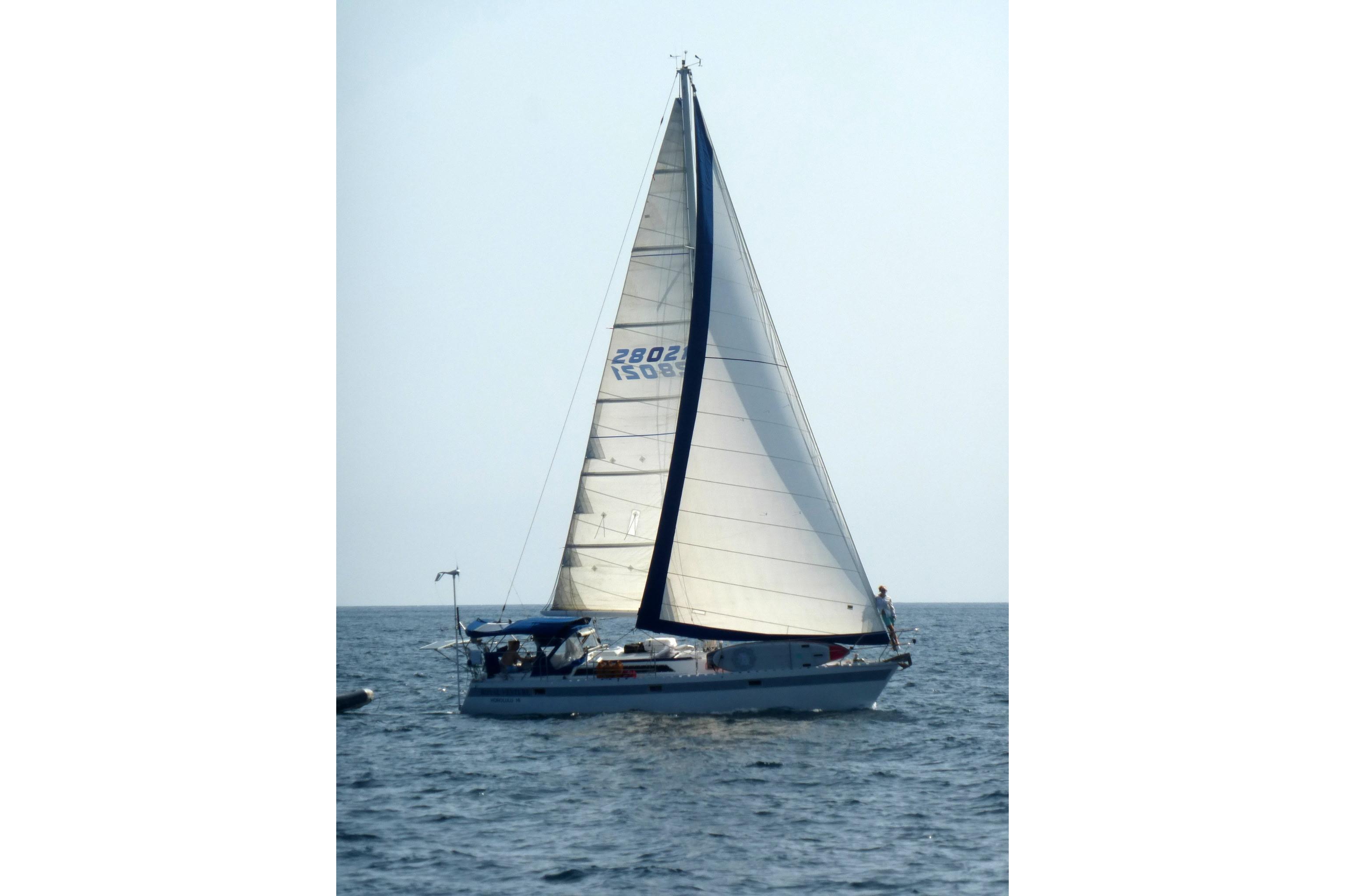 Sailing yacht Norseman 400, 1987 model, gliding on open sea with full sails.