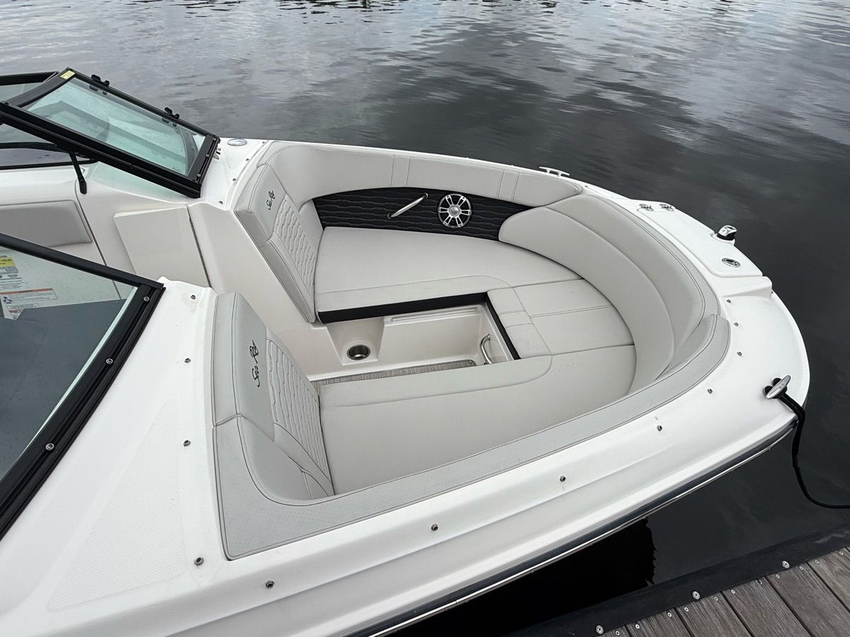 The image shows the bow area of a 2024 Sea Ray SPX 230 Outboard boat with white upholstery.