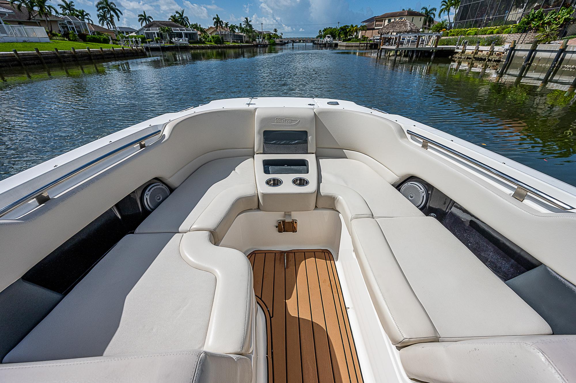 2018 Boston Whaler 270 Vantage boat interior with cushioned seating and wooden deck.