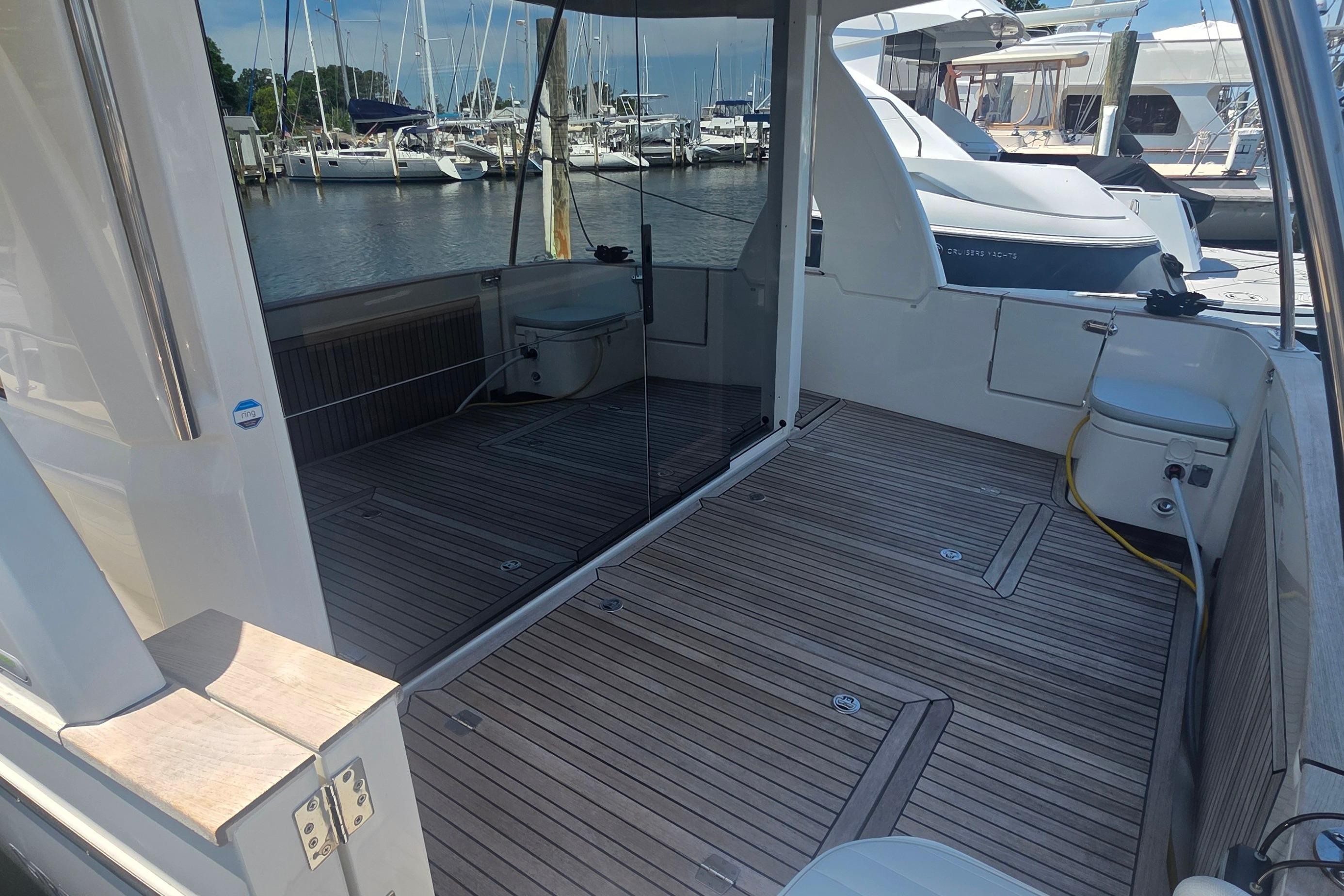 2023 Greenline 40 yacht with spacious teak deck at marina.