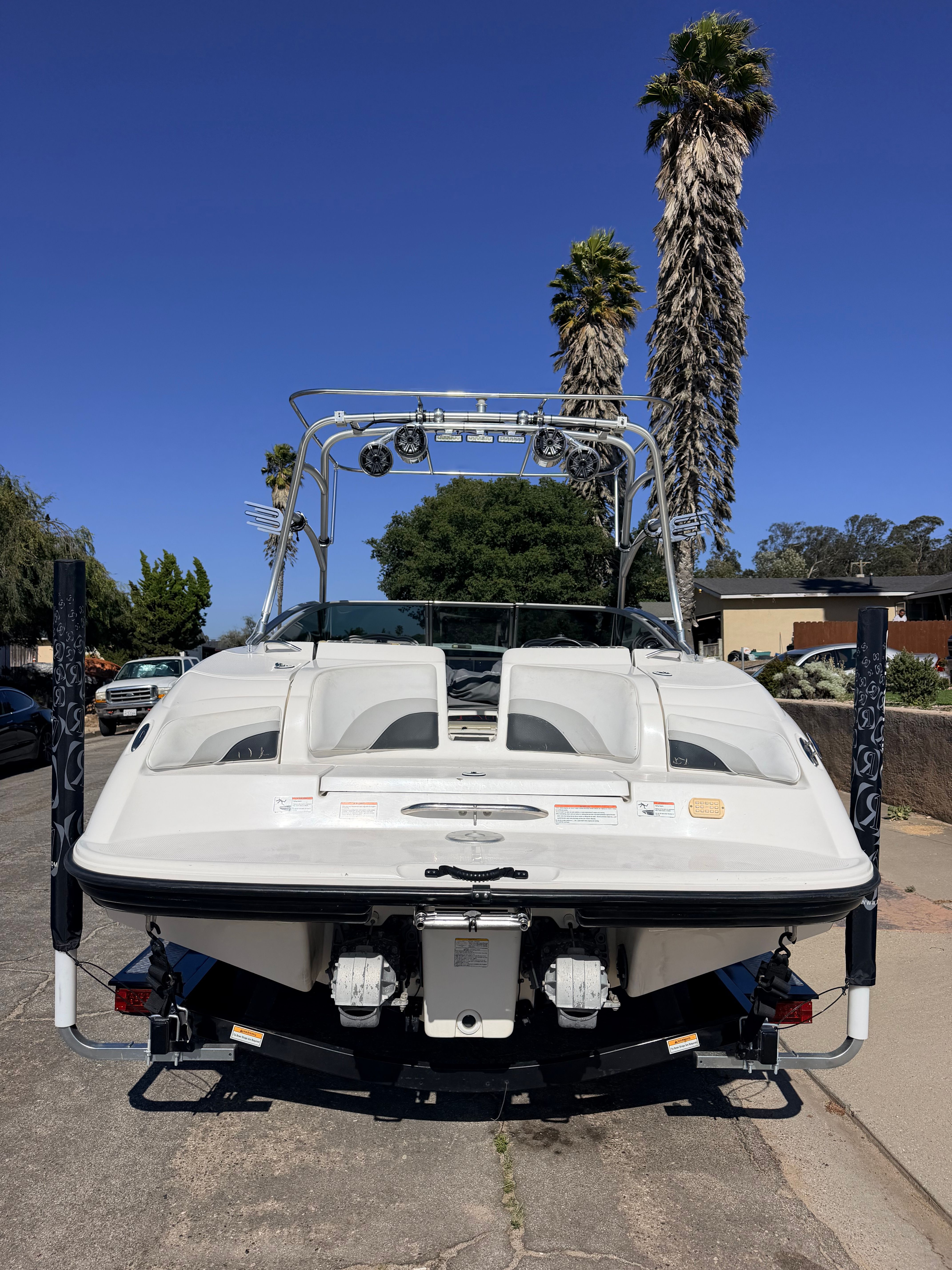 2005 Yamaha AR230 with a white hull and tower, parked on a street.