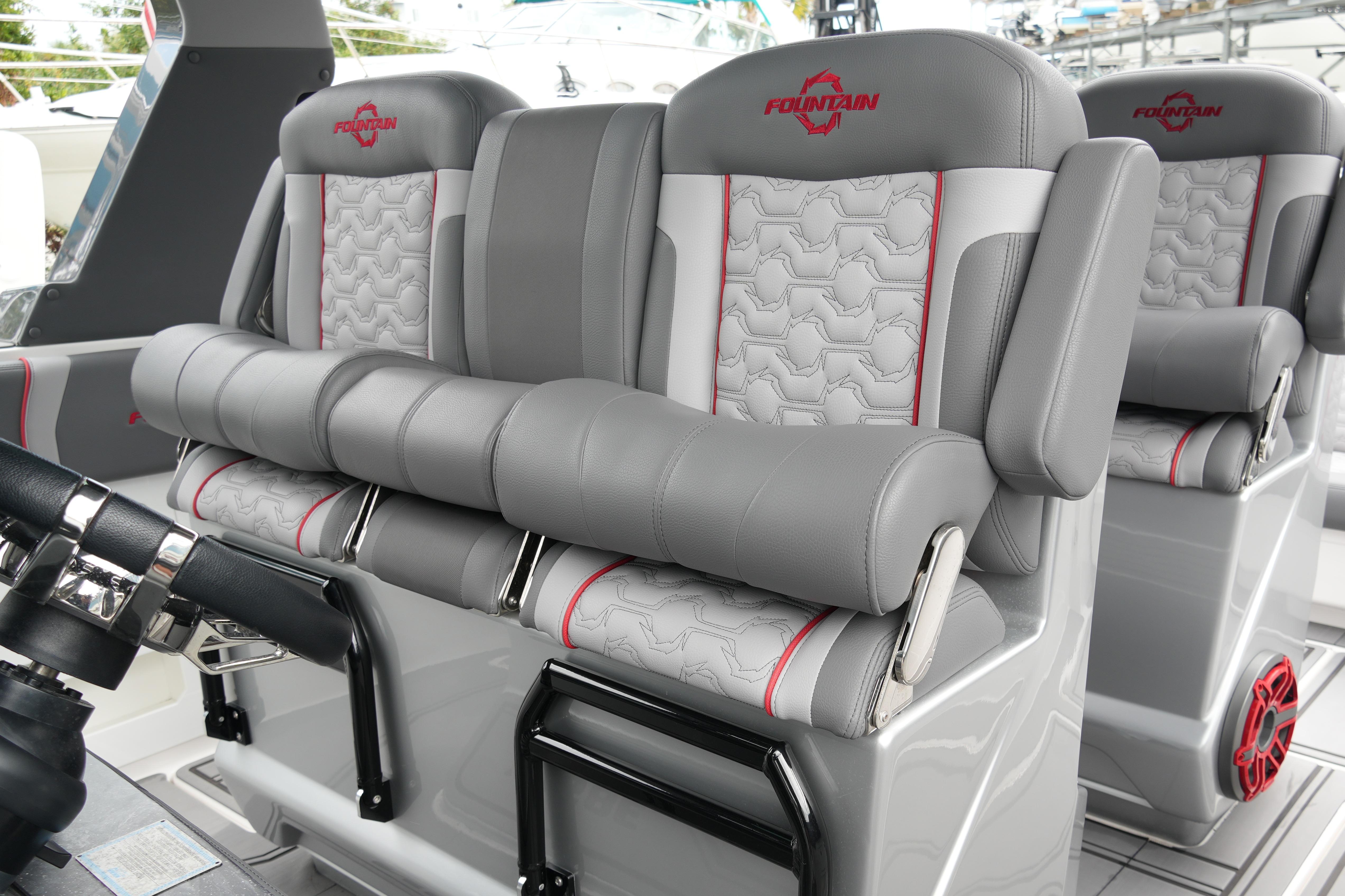 Luxurious seating in 2025 Fountain 38 SCX boat, featuring gray and red upholstery.