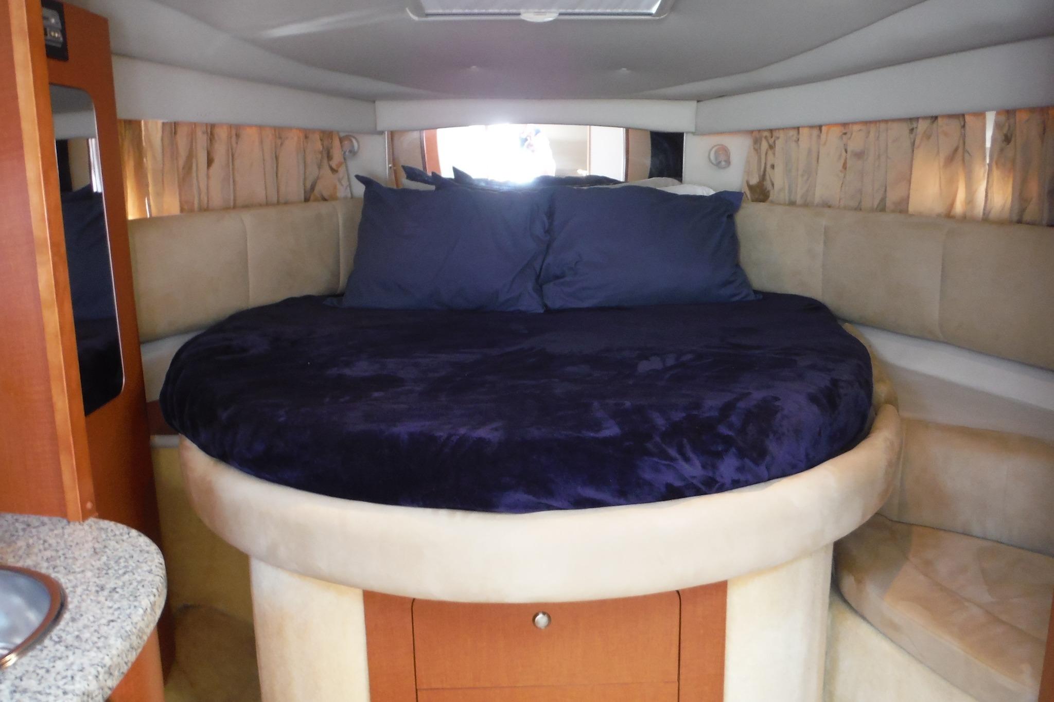Luxurious interior cabin of 2005 Chaparral Signature 350 yacht with plush bedding.