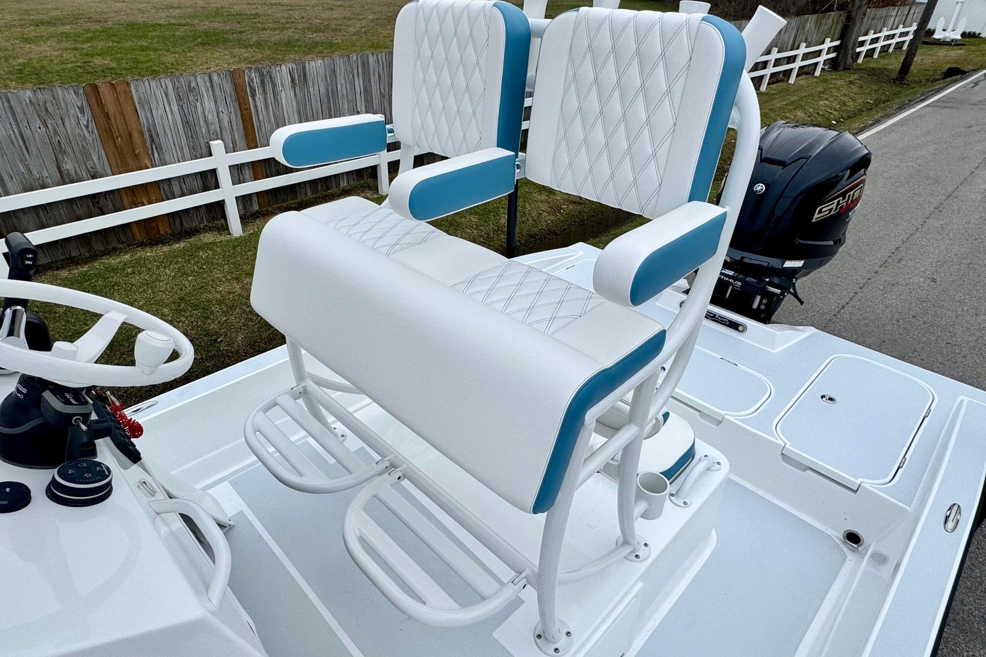 White and blue seating on 2026 Shallow Sport 24 Modified V boat deck.