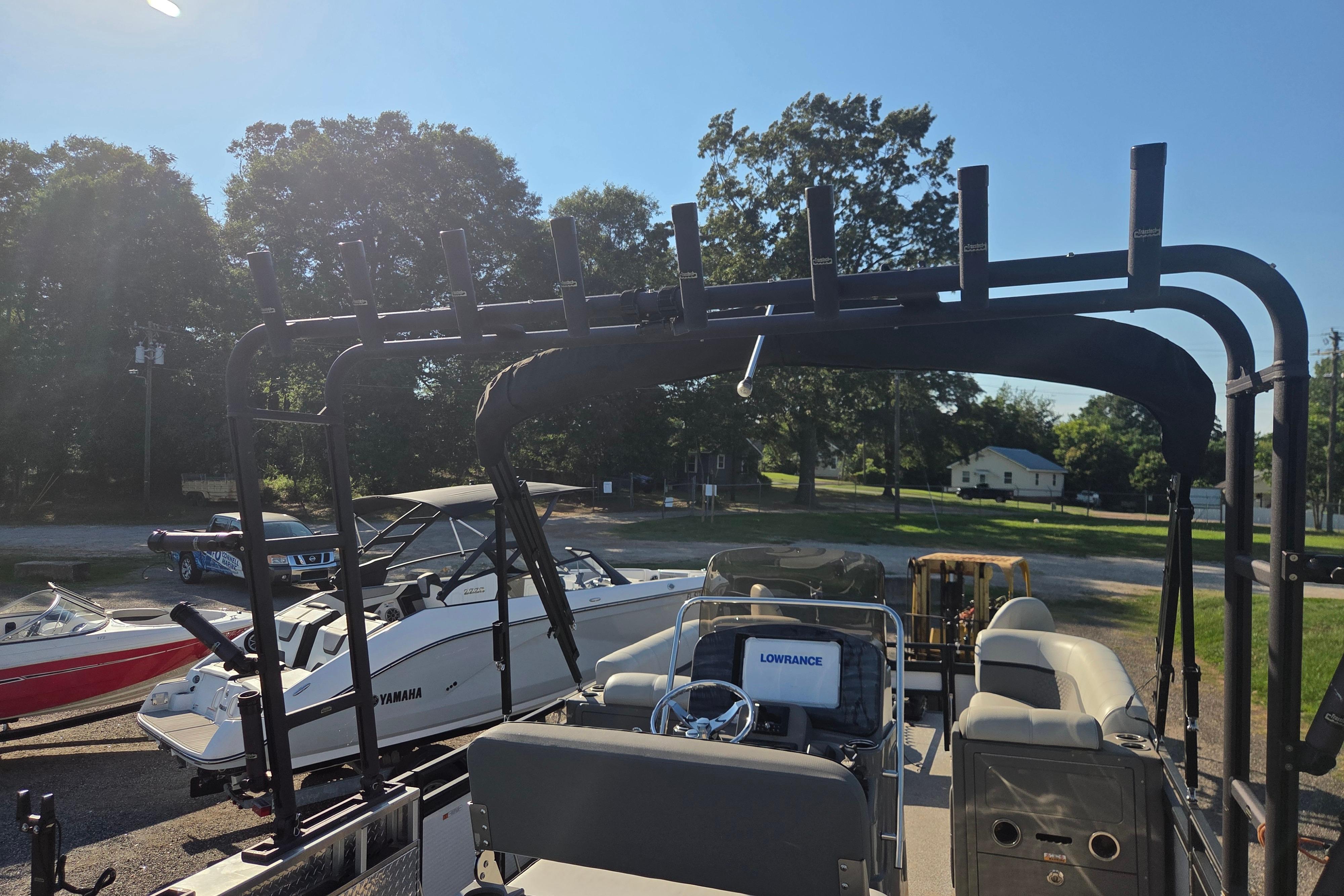 2024 Angler Qwest 8526 Pro Troll boat with fishing rod holders and Lowrance equipment.