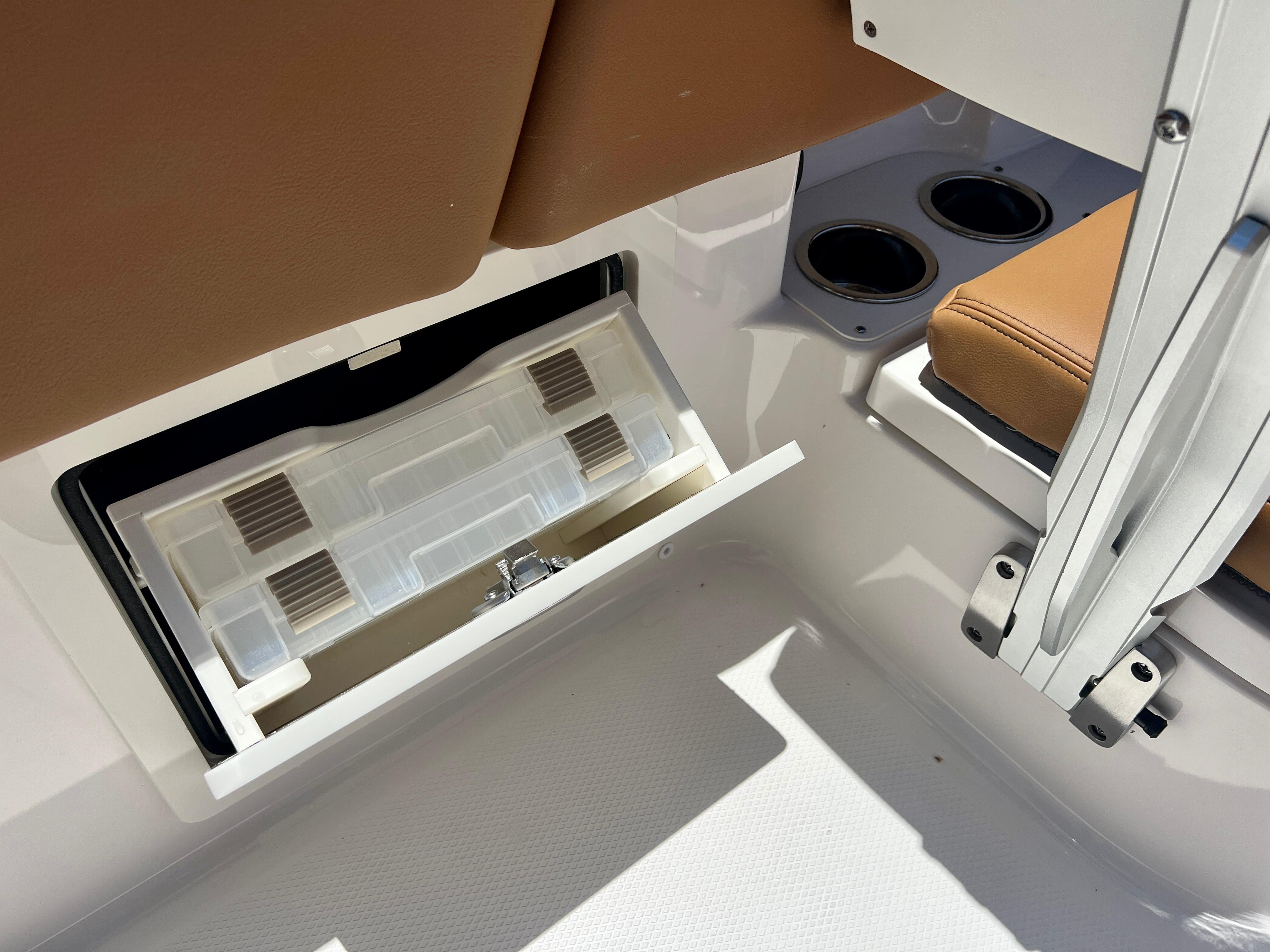 Robalo 266 Cayman 2025, seating area with storage and cup holders.
