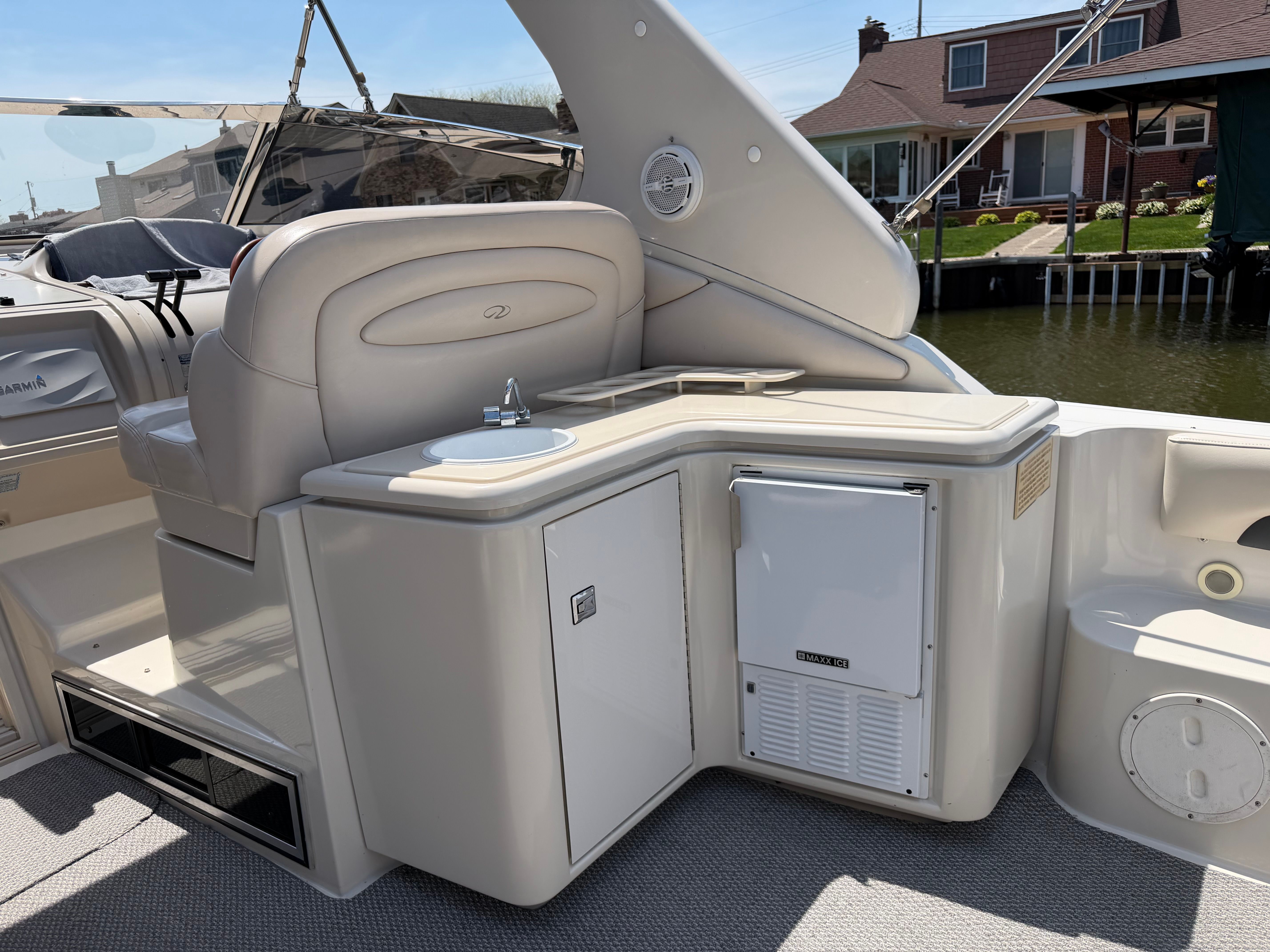 Interior of a 1997 Regal Commodore yacht with seating and fridge.