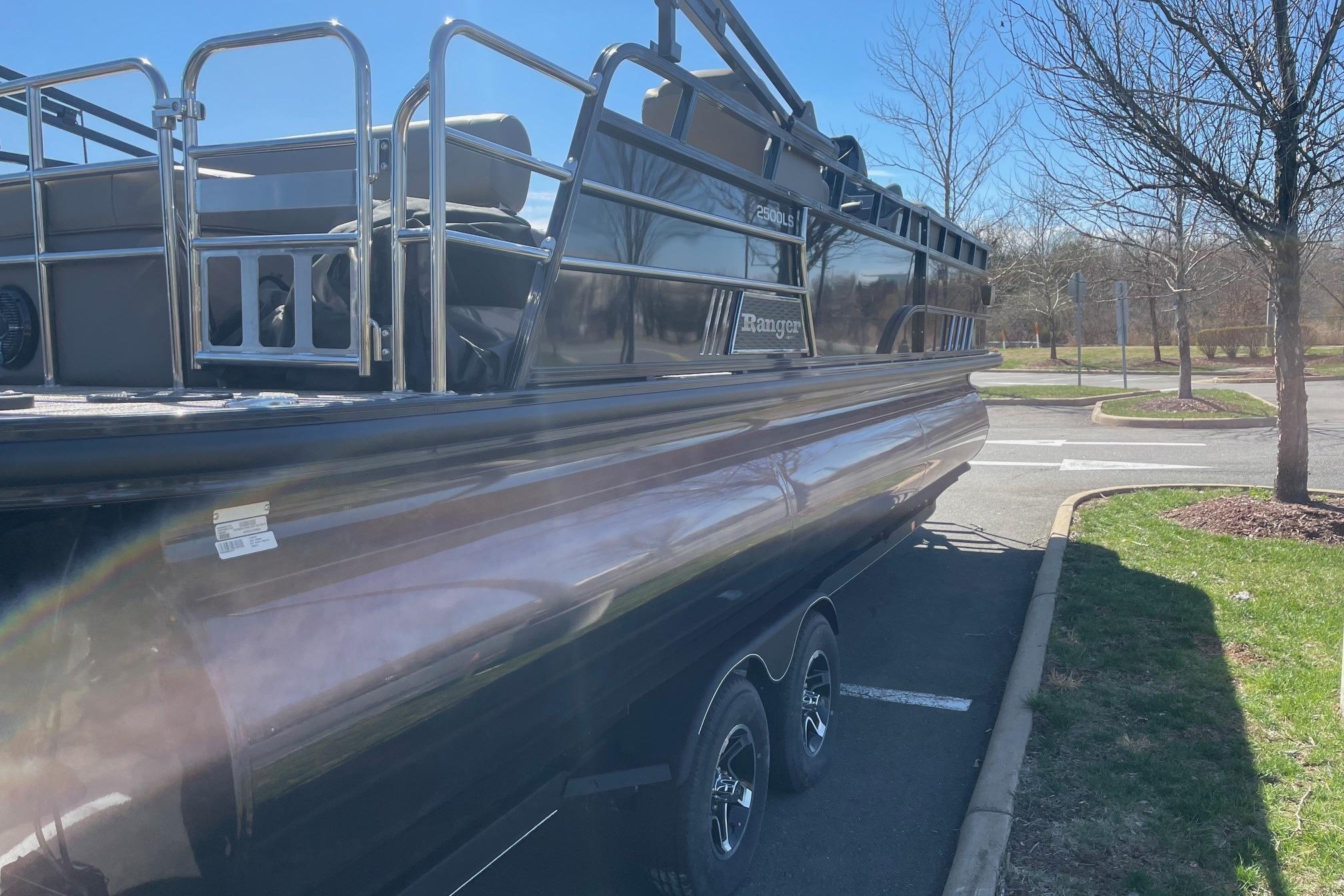 2024 Ranger 2500LS pontoon boat parked outdoors on a sunny day.