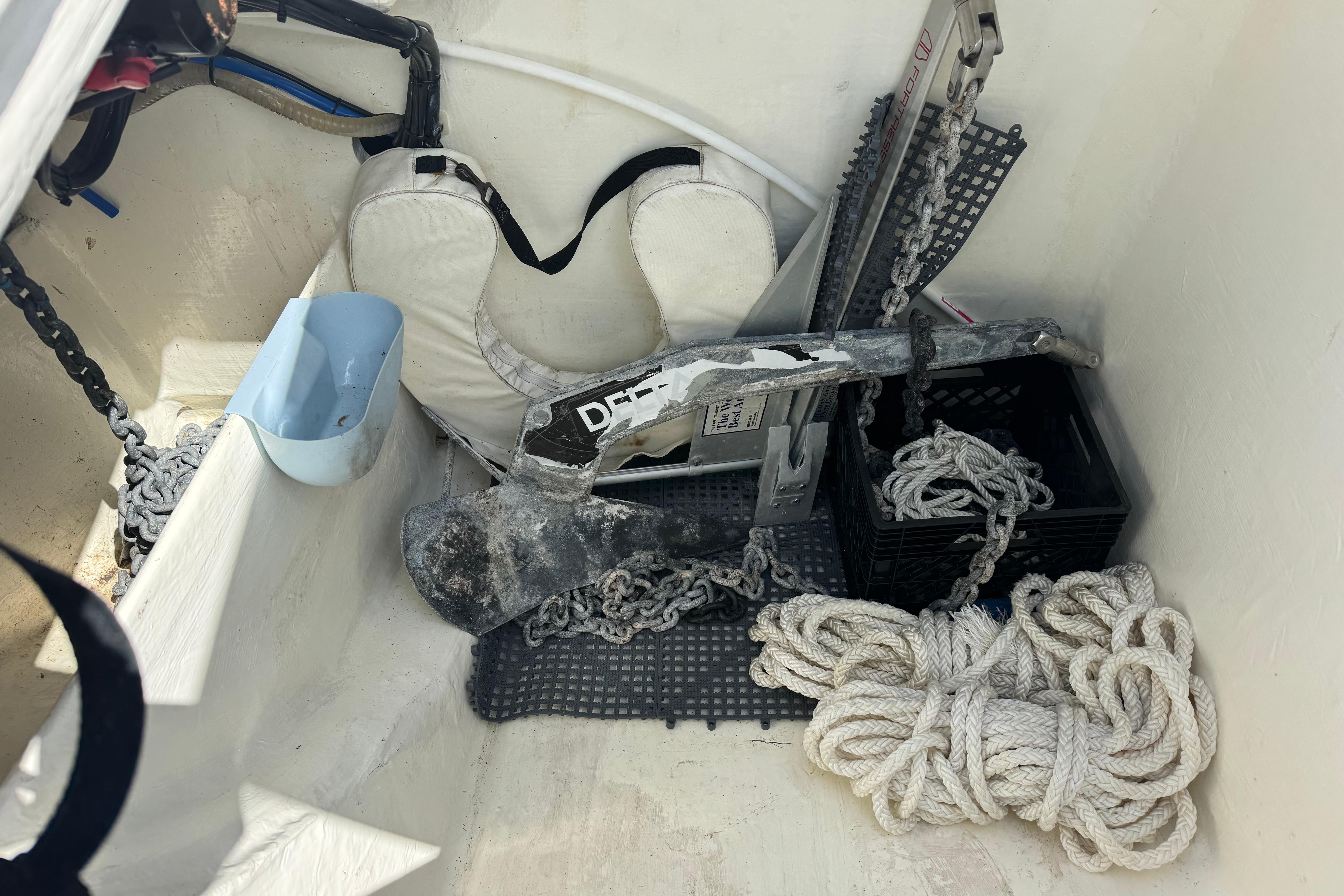 Storage compartment of 2021 Leopard 53 Powercat with anchor, ropes, and life jacket.