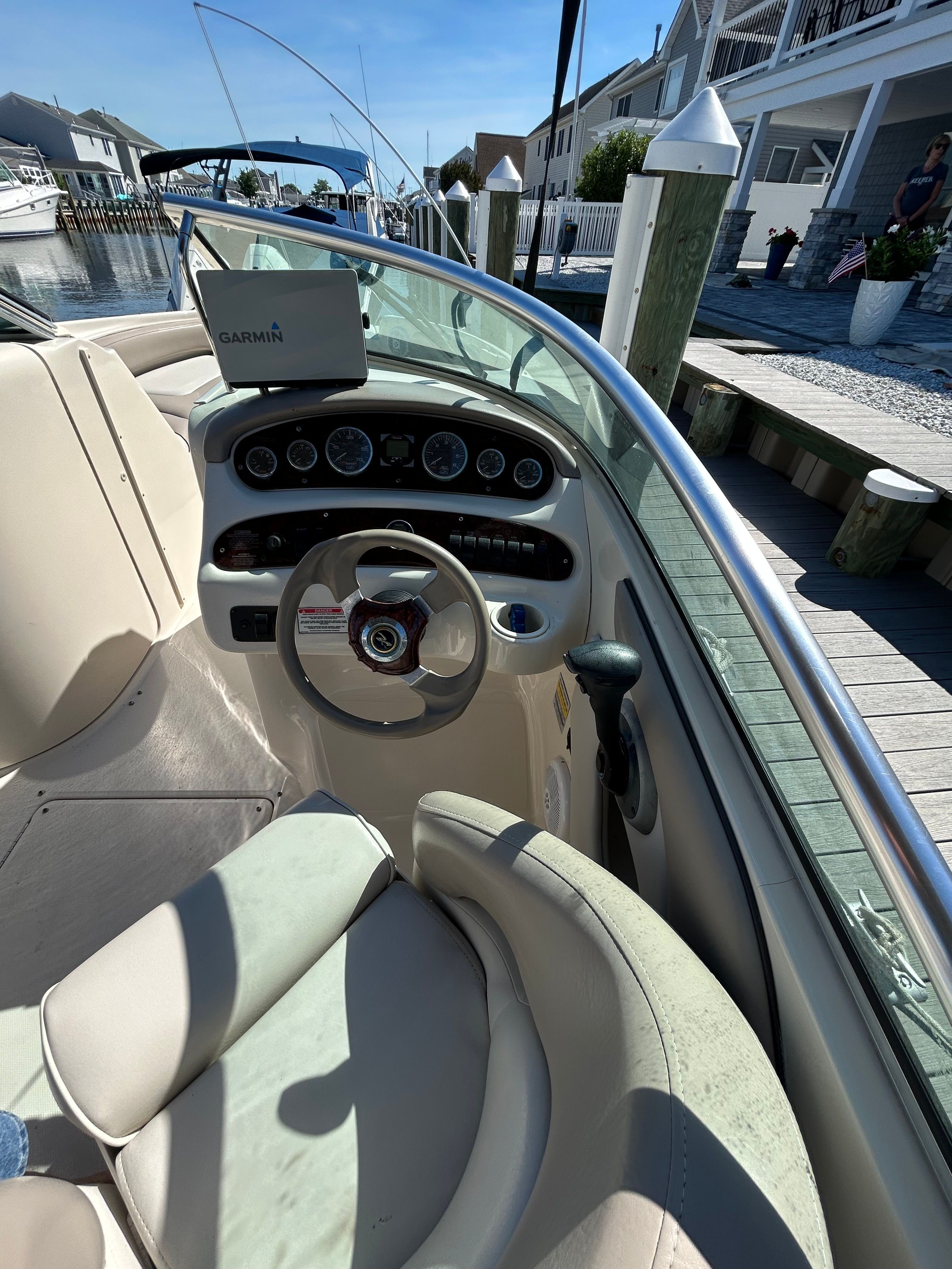 Helm of a 2003 Sea Ray 240 Sundeck boat at dock.