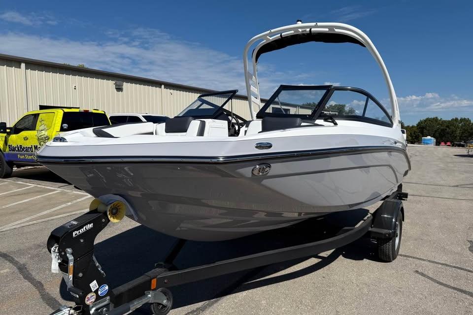 2026 Yamaha Boats 195S on trailer, sleek design, parked outdoors under clear sky.
