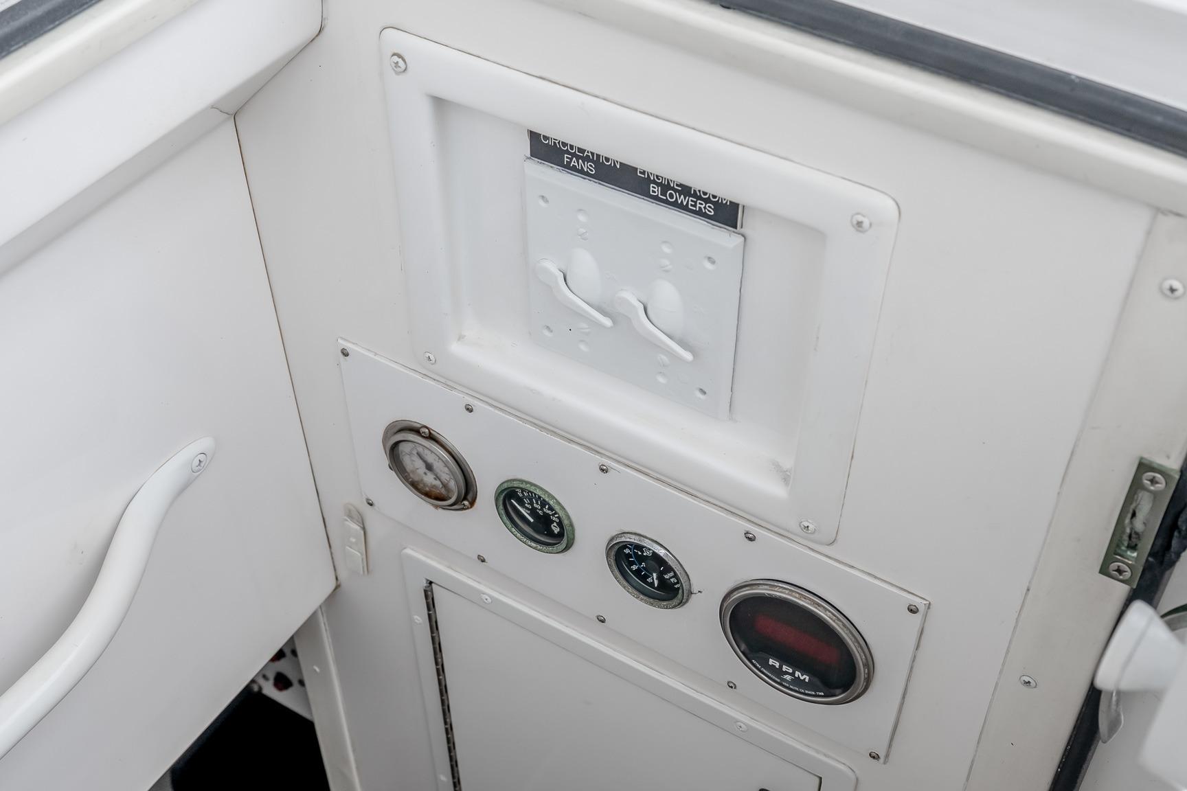 Control panel of a 2000 Viking 50' Convertible yacht with gauges and switches.