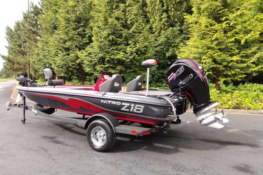 2026 Nitro Z18 Pro boat with sleek design, parked on a trailer, surrounded by lush greenery.
