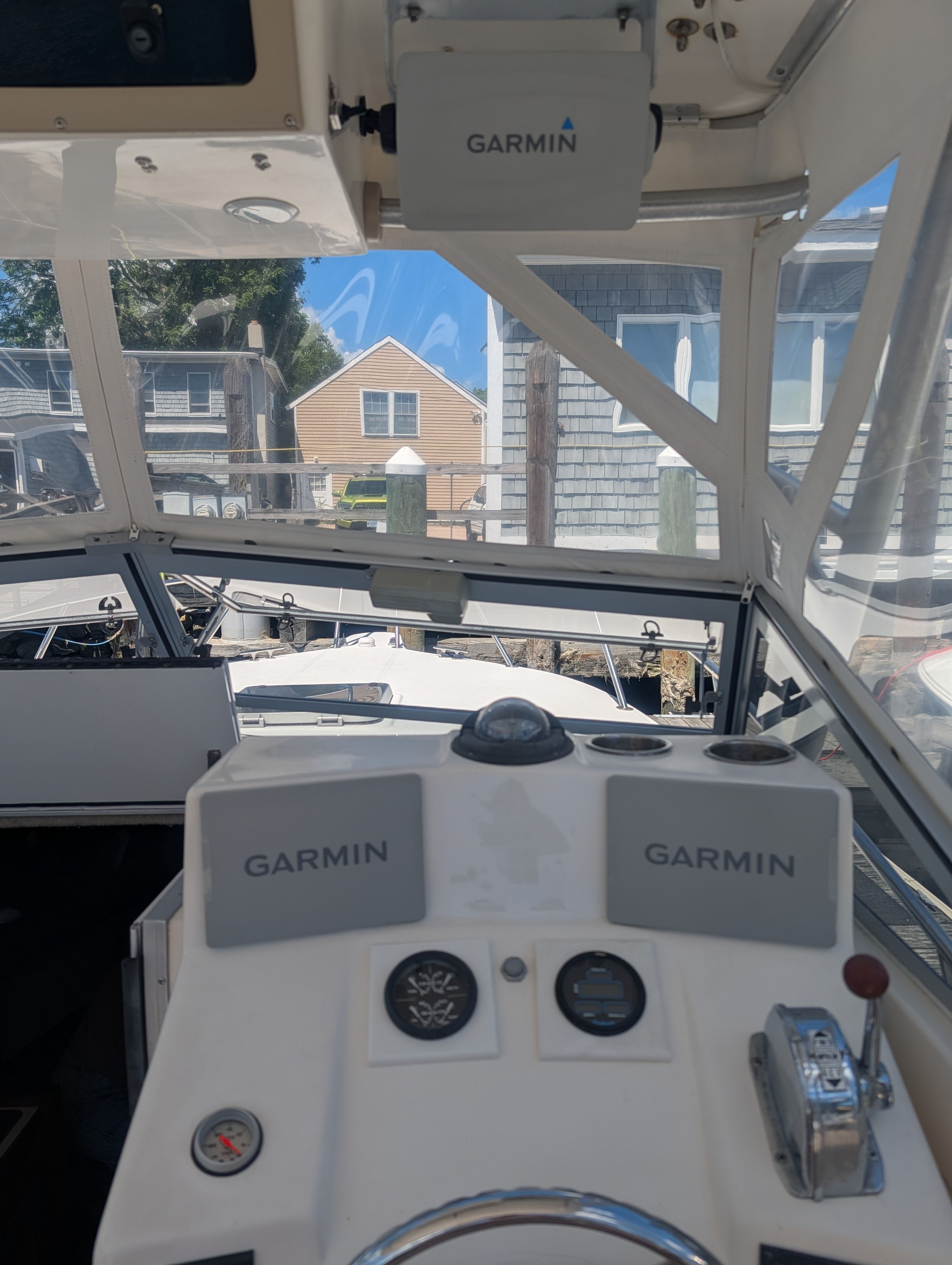 Interior view of a boat with Garmin devices and controls.