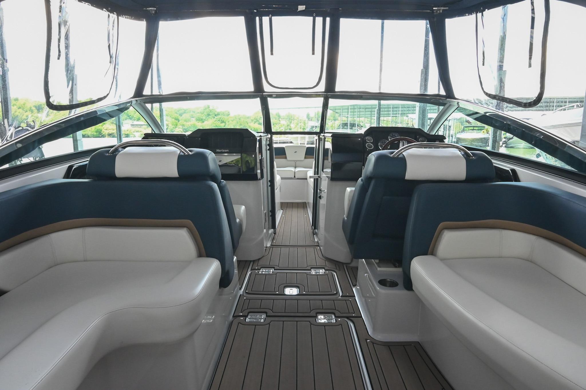 Interior of 2014 Four Winns H290 boat with luxurious seating and modern dashboard.