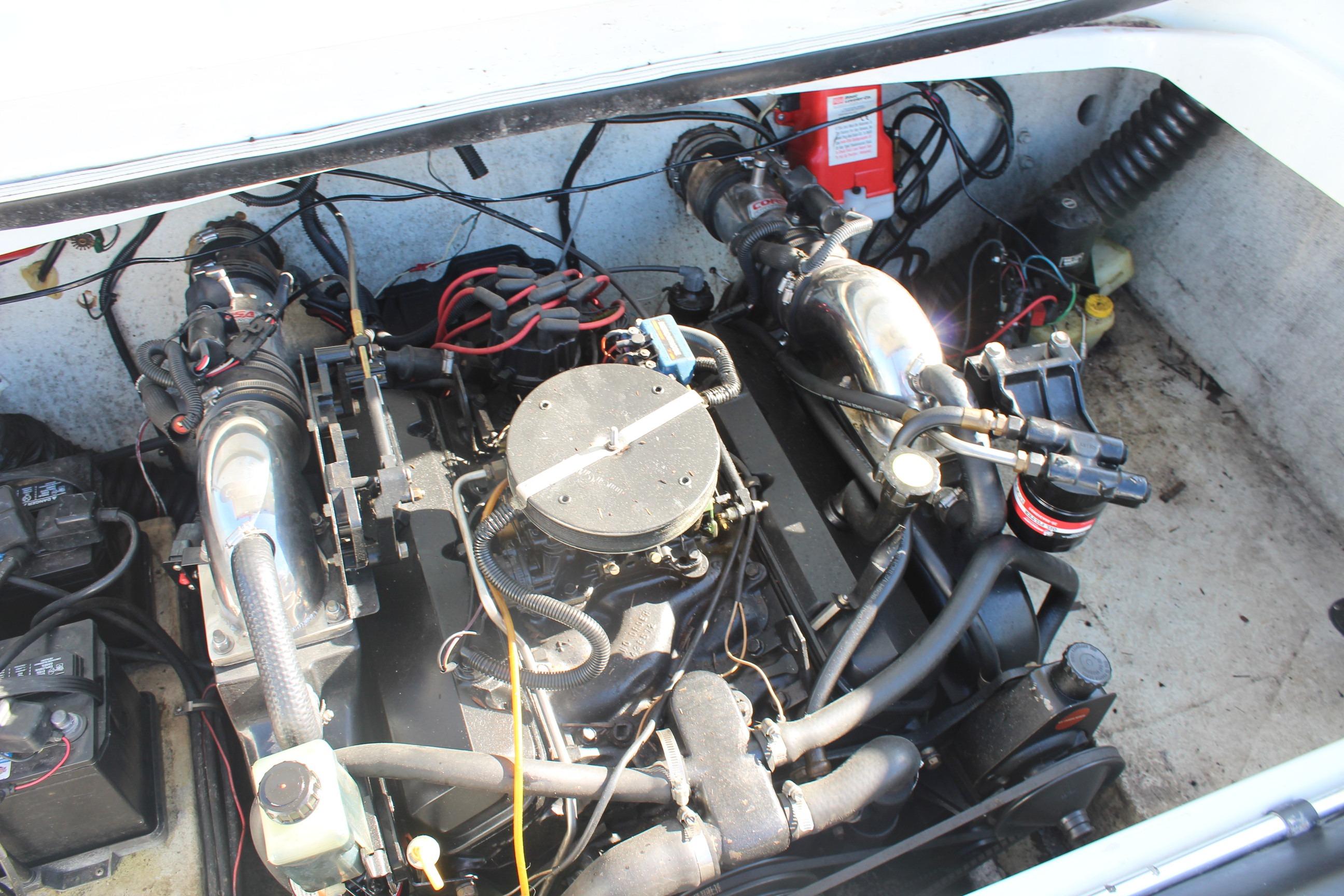 Engine compartment of a 1996 Baja 232 boat, showcasing mechanical components.