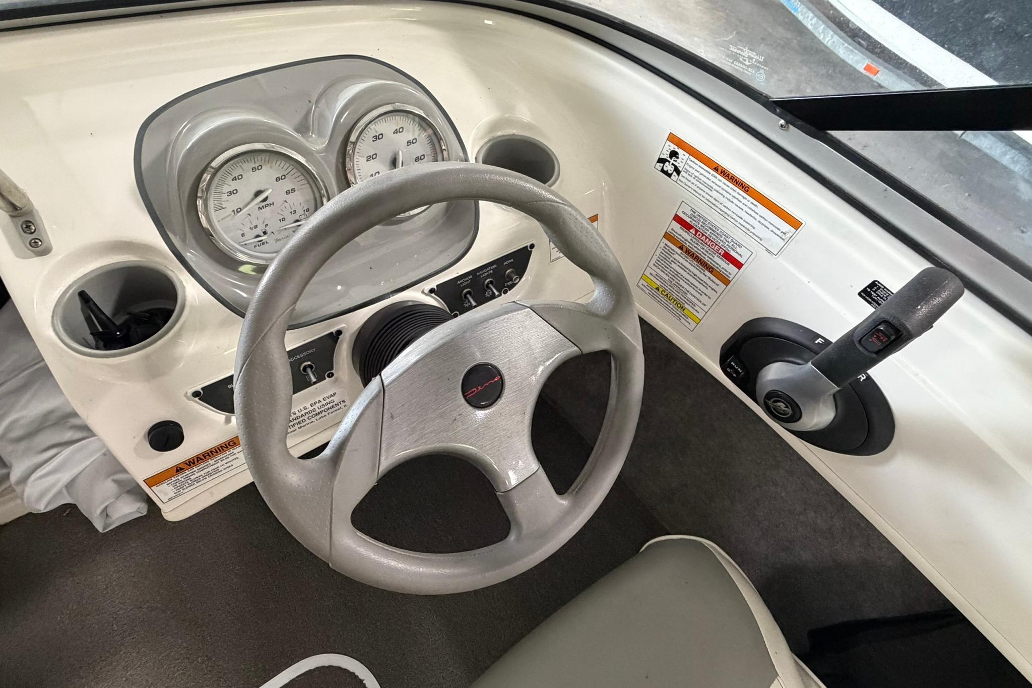 2012 Bayliner 175 Bowrider dashboard with steering wheel and control panel.