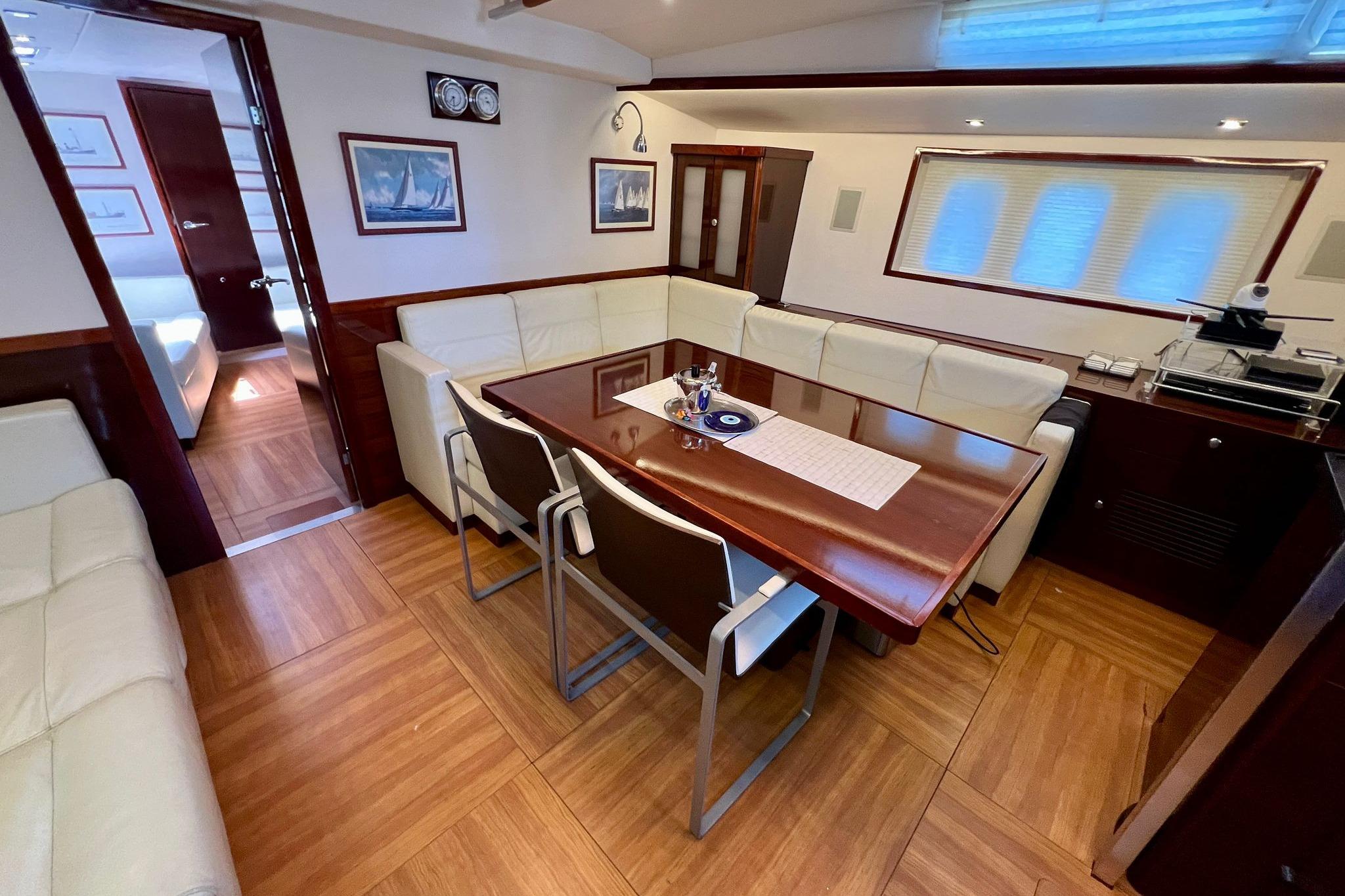 Luxurious interior of 2010 Hanse 630e yacht with elegant dining area and modern furnishings.