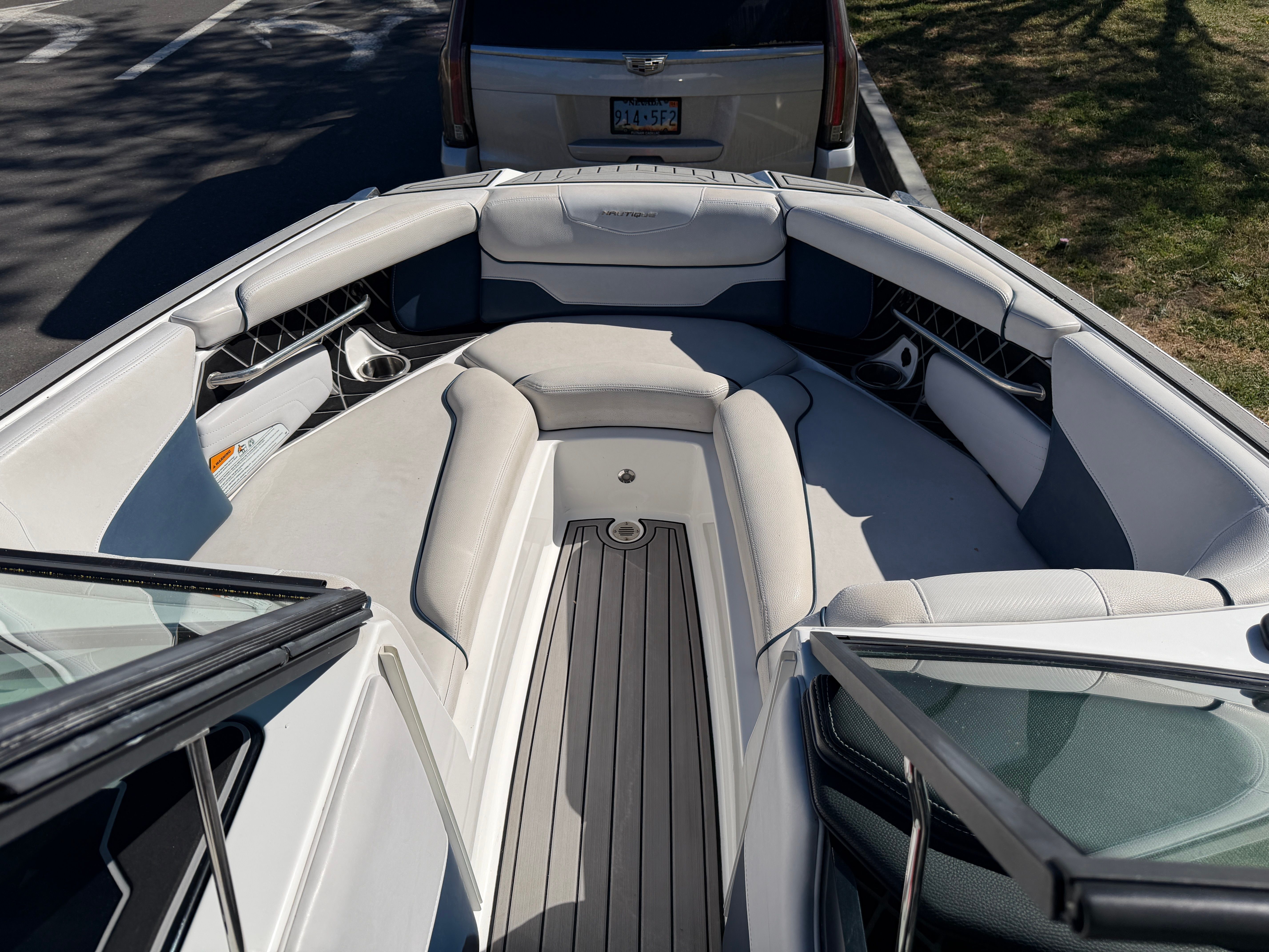 The image shows the bow of a 2018 Nautique Super Air Nautique GS22 with gray upholstery.