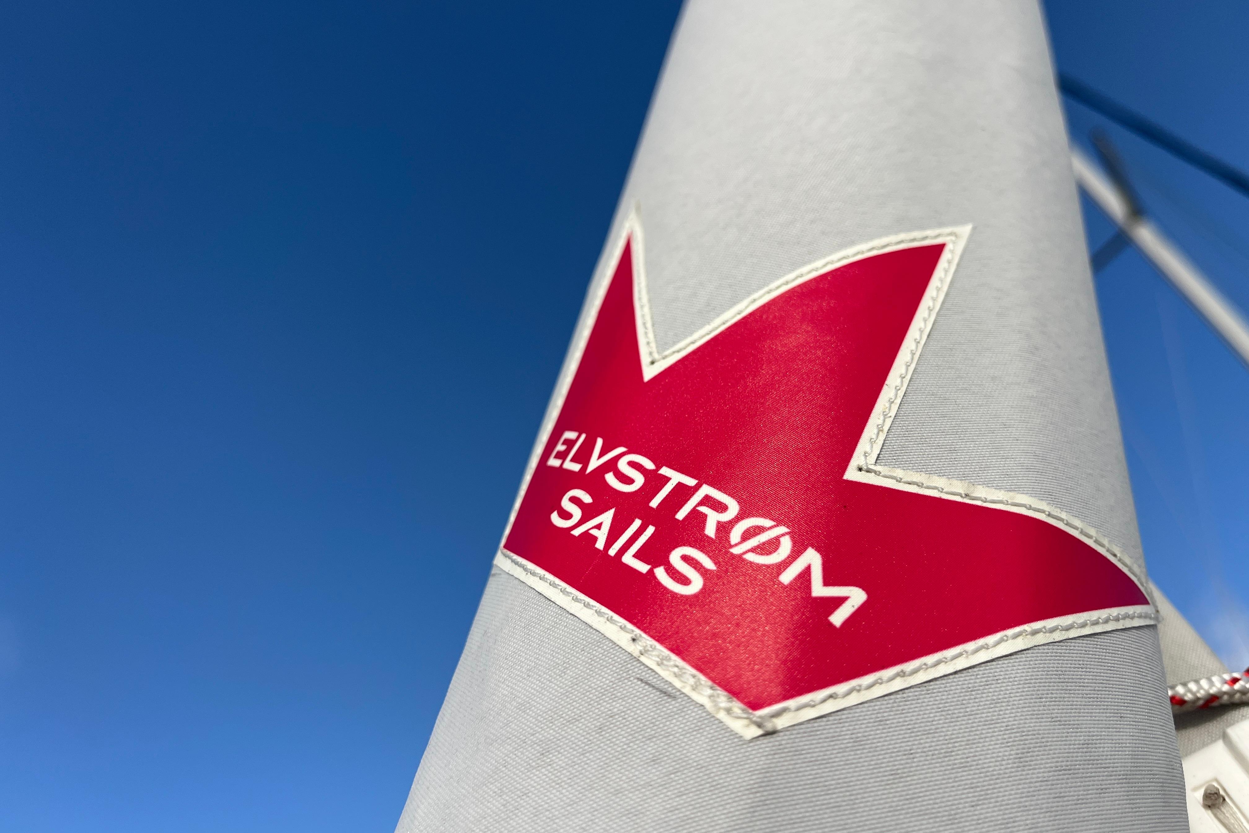 Elvstrøm Sails logo on Hanse 360 yacht, 2025 model, against clear blue sky.