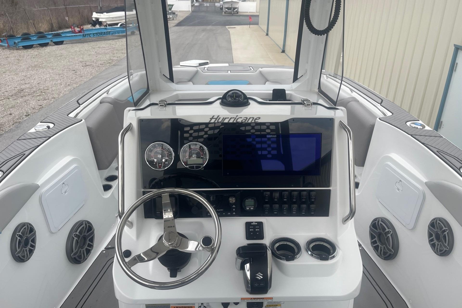 2025 Hurricane Center Console 24 OB boat dashboard with steering wheel and controls.