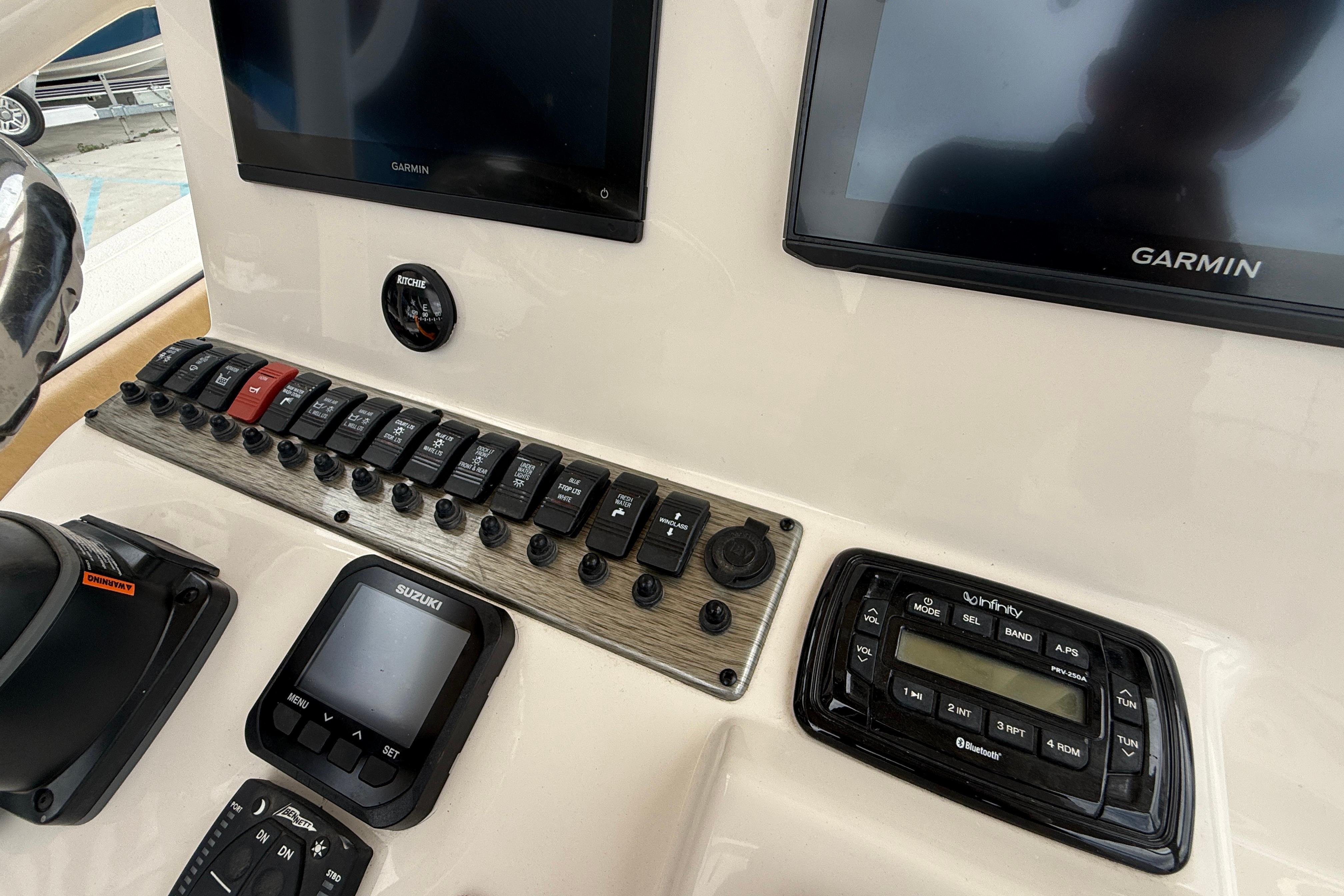 Control panel of 2023 SeaChaser 24 HFC boat with Garmin displays and switches.