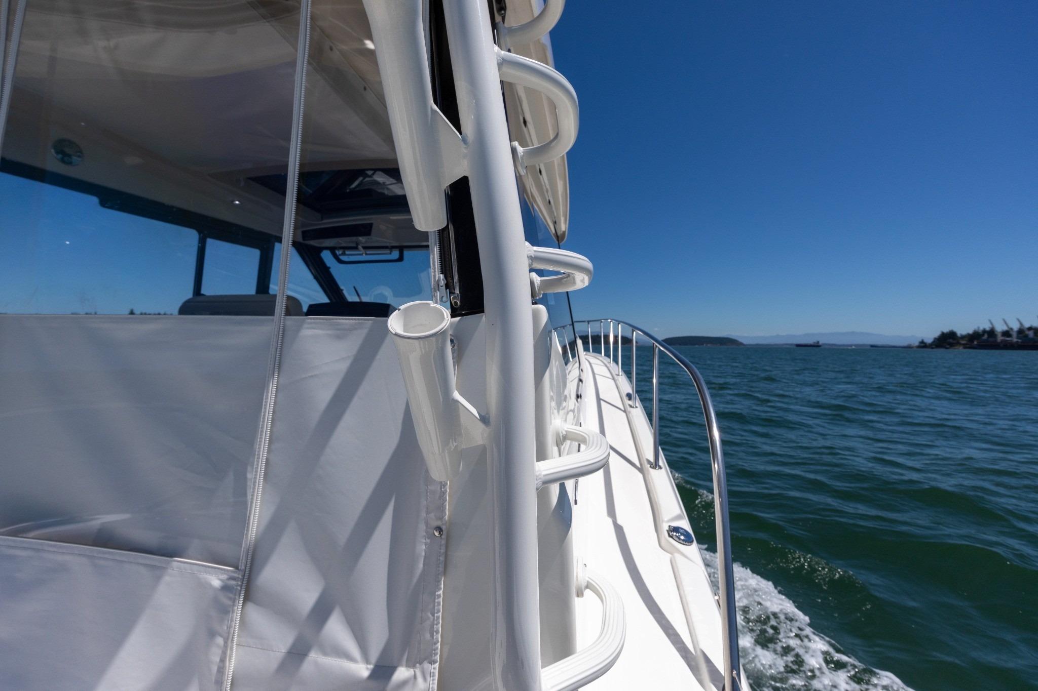 2023 Boston Whaler 405 Conquest cruising on open water under clear blue skies.